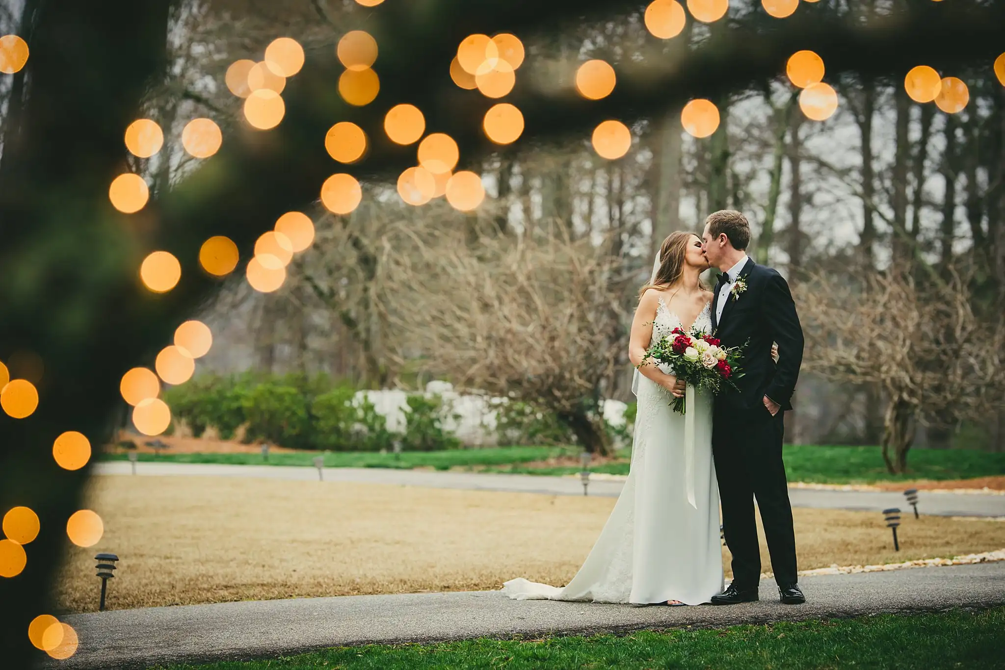 2019-04-22_0034.jpg Wedding Formals: the couple kissing under the string lights, at their wedding at Little River Farms in Milton, GA