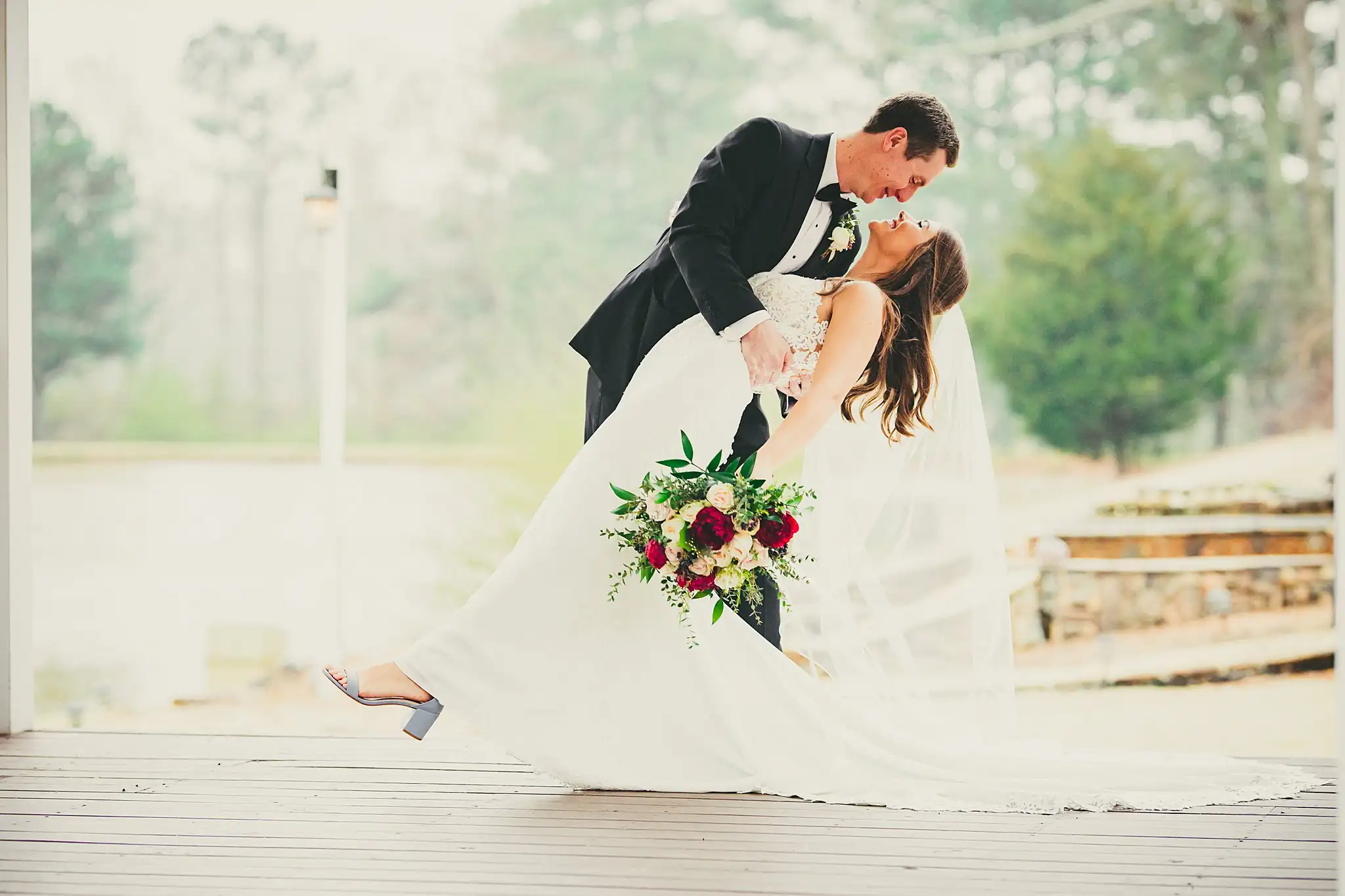 2019-04-22_0038.jpg Wedding Formals: the groom dipping the bride for a kiss outdoors, at their wedding at Little River Farms in Milton, GA