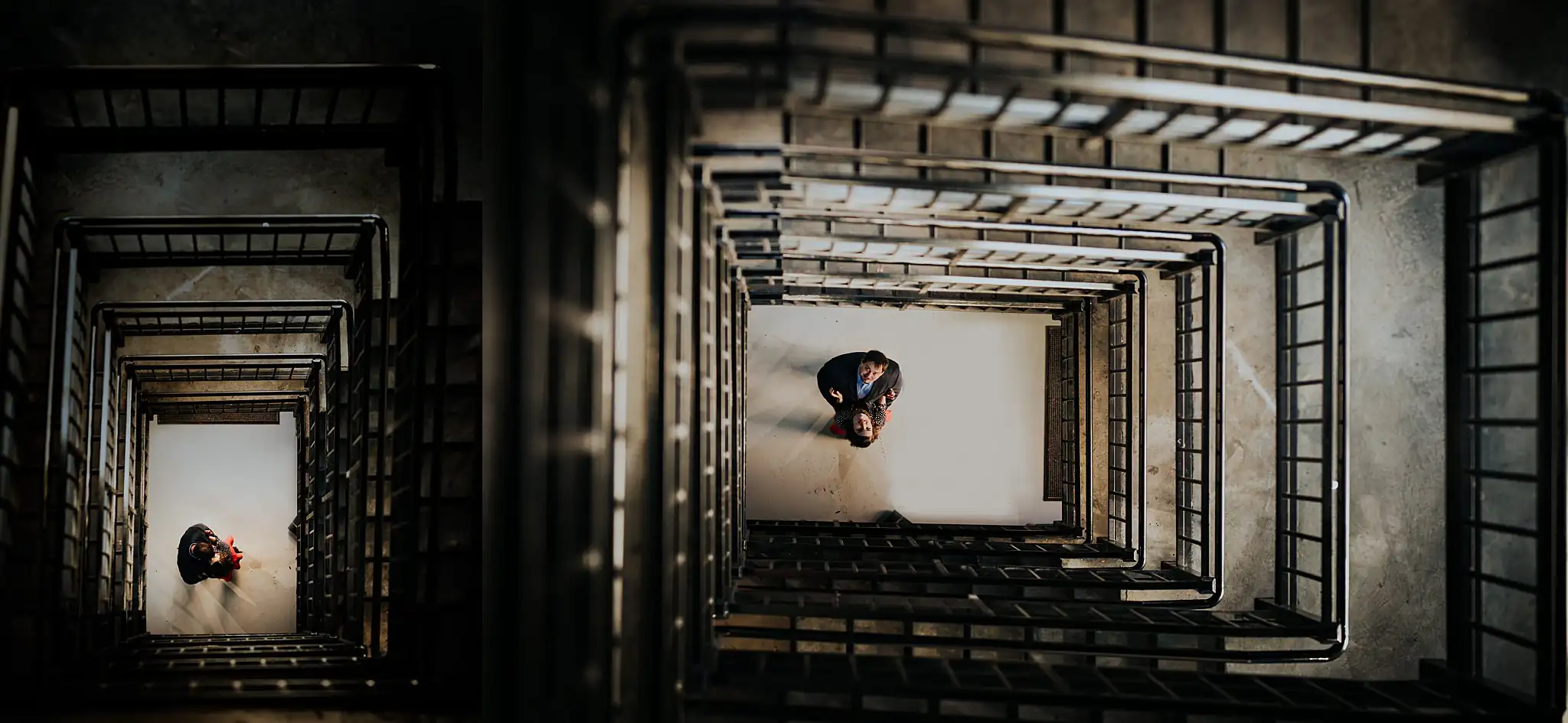 AtlantaWeddingPhotographers_0374.jpg Engagement Portraits: the two of them far below in the parking deck stairwell, in a set, during their engagement session in downtown Athens, GA