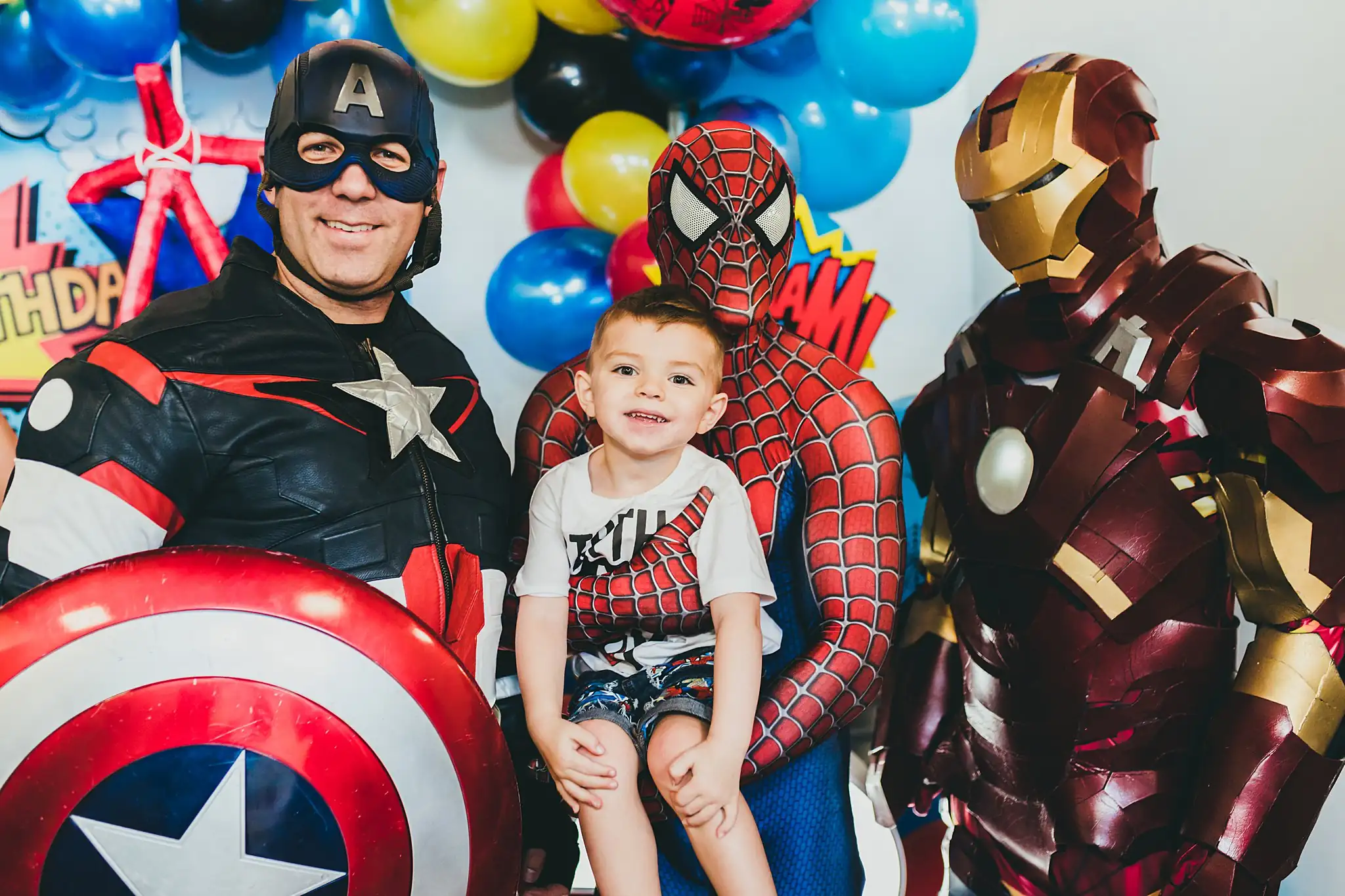 Party: a boy between Captain America, Spider-Man and Iron Man, at a third birthday party at Oodazu in Atlanta, GA