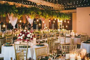 Wedding reception under a greenery canopy and string lights at Westside Warehouse in Atlanta, GA