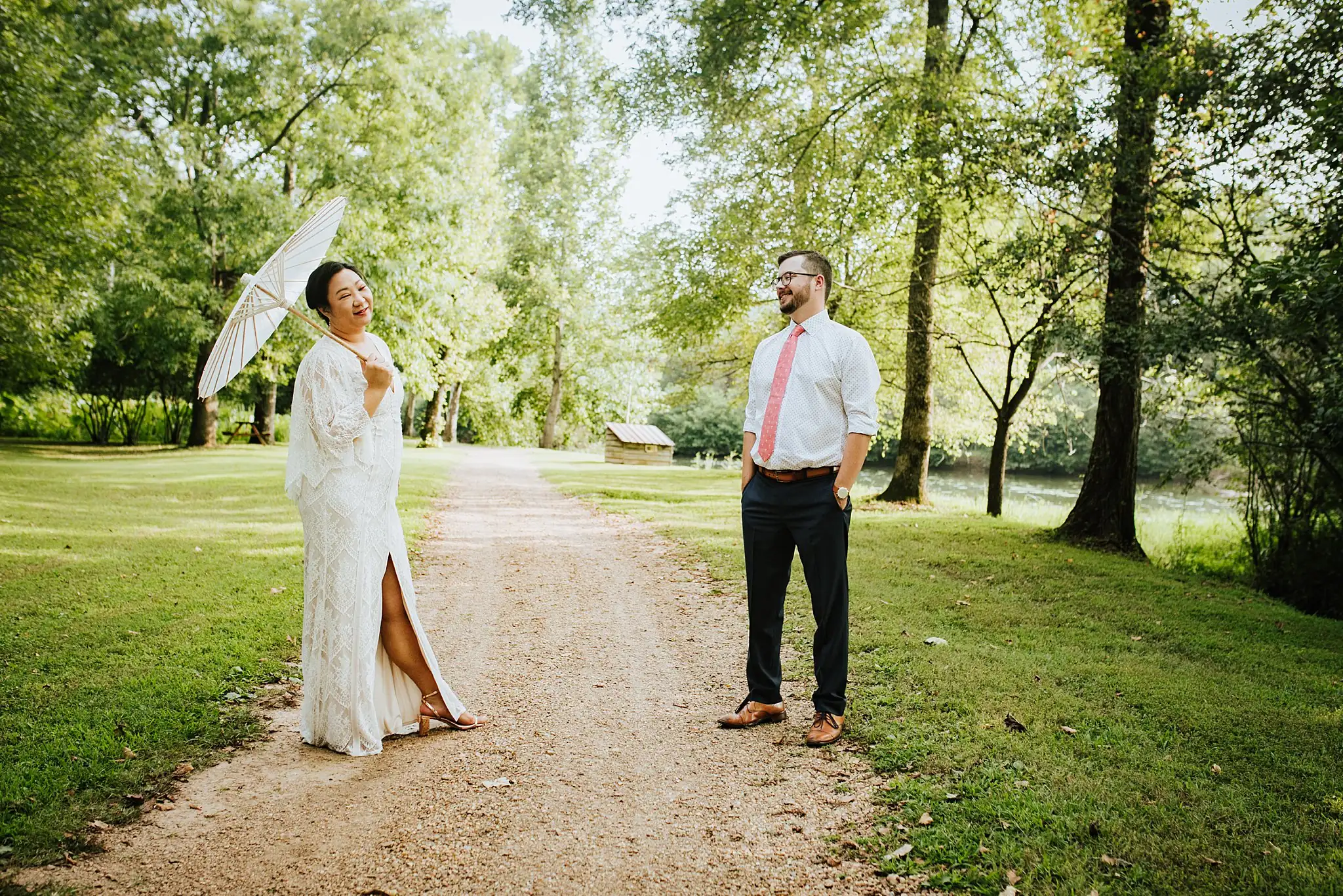 AtlantaWeddingPhotographers_0483.jpg Wedding Formals: the bride with her parasol, the groom facing her on the drive, at their wedding at Barnsley Gardens Resort in Adairsville, GA