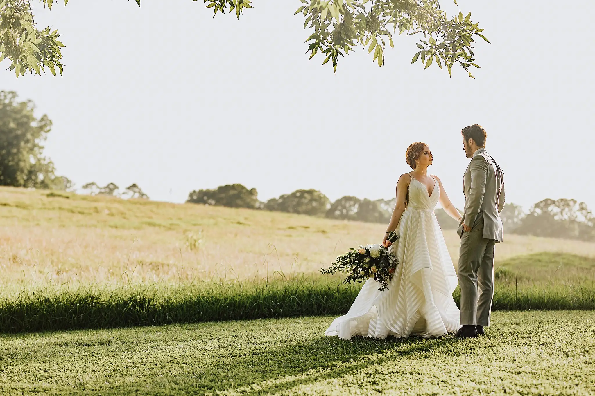 AtlantaWeddingPhotographers_0507.jpg Wedding Formals: the couple facing each other in the open pasture, at a Wedding styled shoot at The Venue at Murphy Lane in Newnan, GA