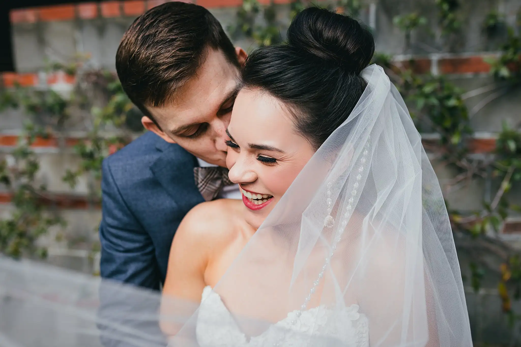 Wedding Formals: the couple close together beneath her veil, at their wedding at the Westside Warehouse in Atlanta, GA
