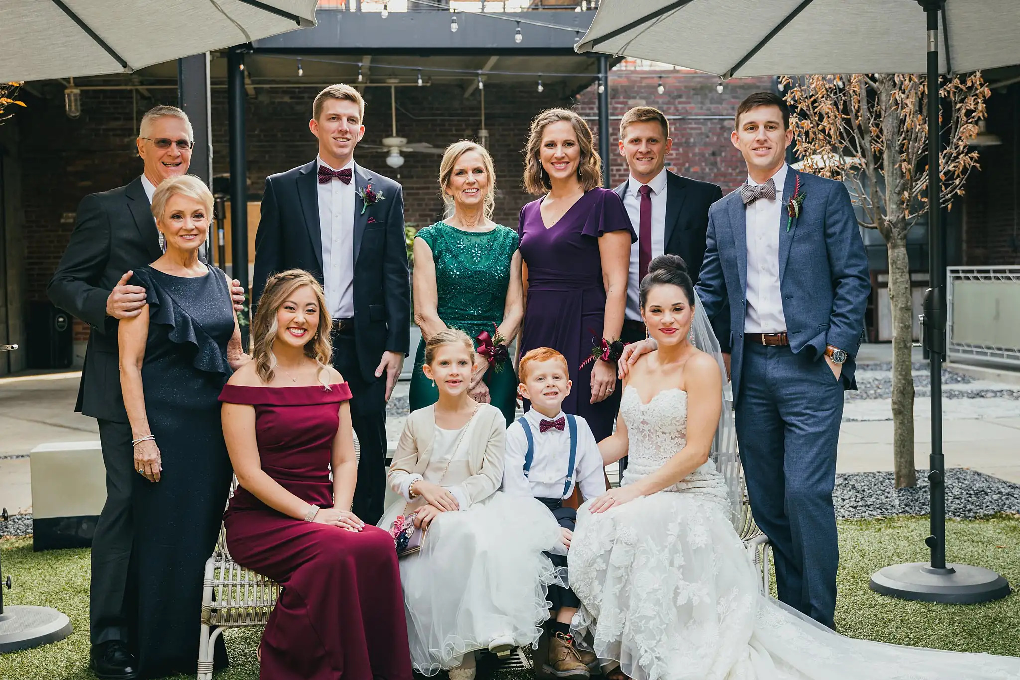 Wedding Party: the family gathered together under the canopy, at their wedding at the Westside Warehouse in Atlanta, GA