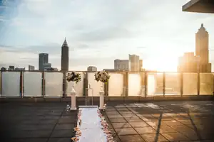 Wedding Ceremony: a rooftop aisle strewn with petals at sunset, at a wedding
