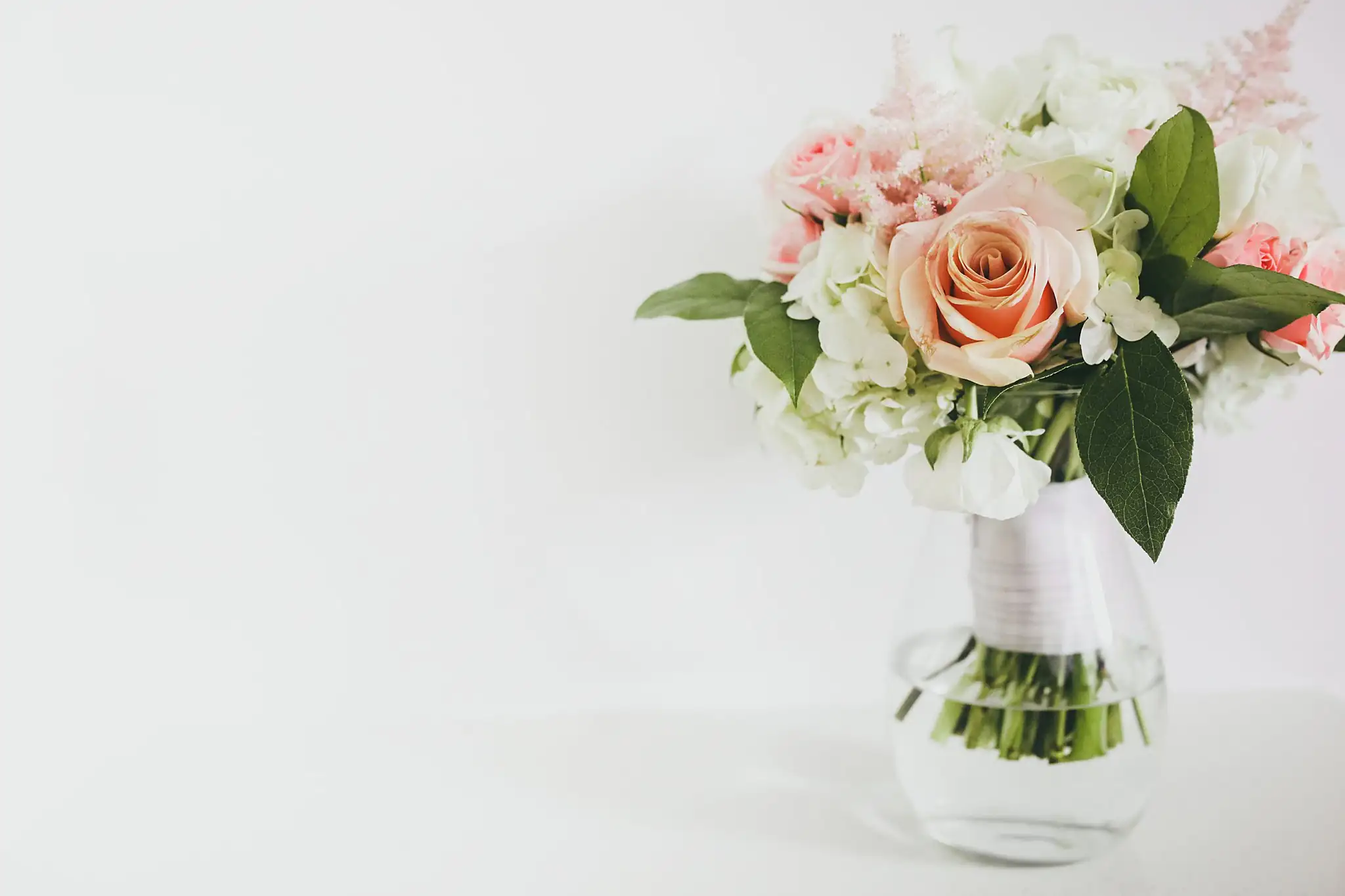 Wedding Florals: the blush and peach rose bouquet in its glass vase, at an elopement at Ventanas in Atlanta, GA