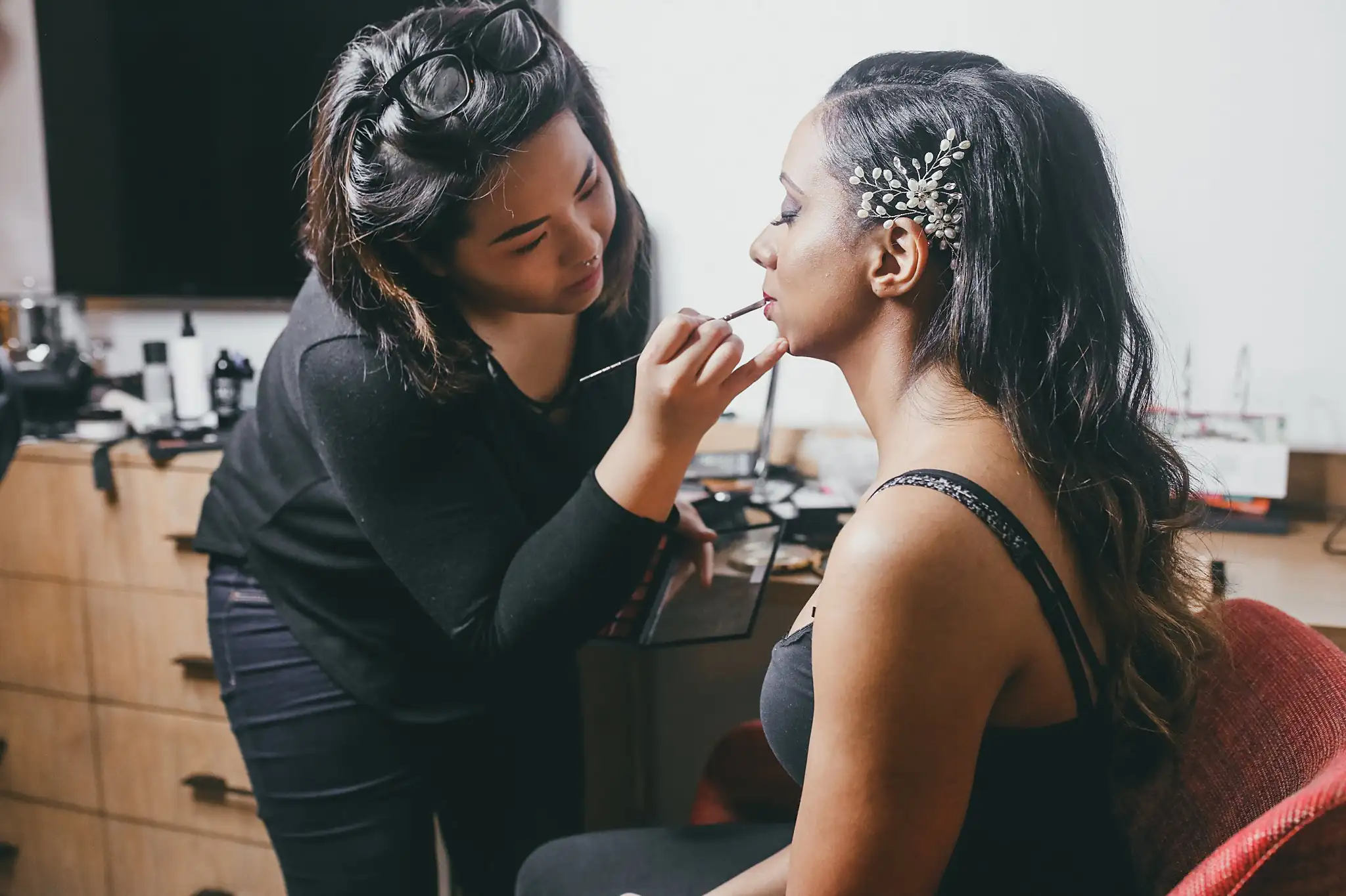 Getting Ready: a makeup artist finishing the bride's lipstick, before their elopement at Ventanas in Atlanta, GA