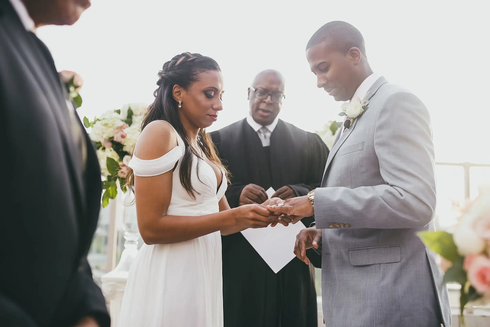 Wedding Ceremony: the rings being exchanged in front of the officiant, at their elopement at Ventanas in Atlanta, GA