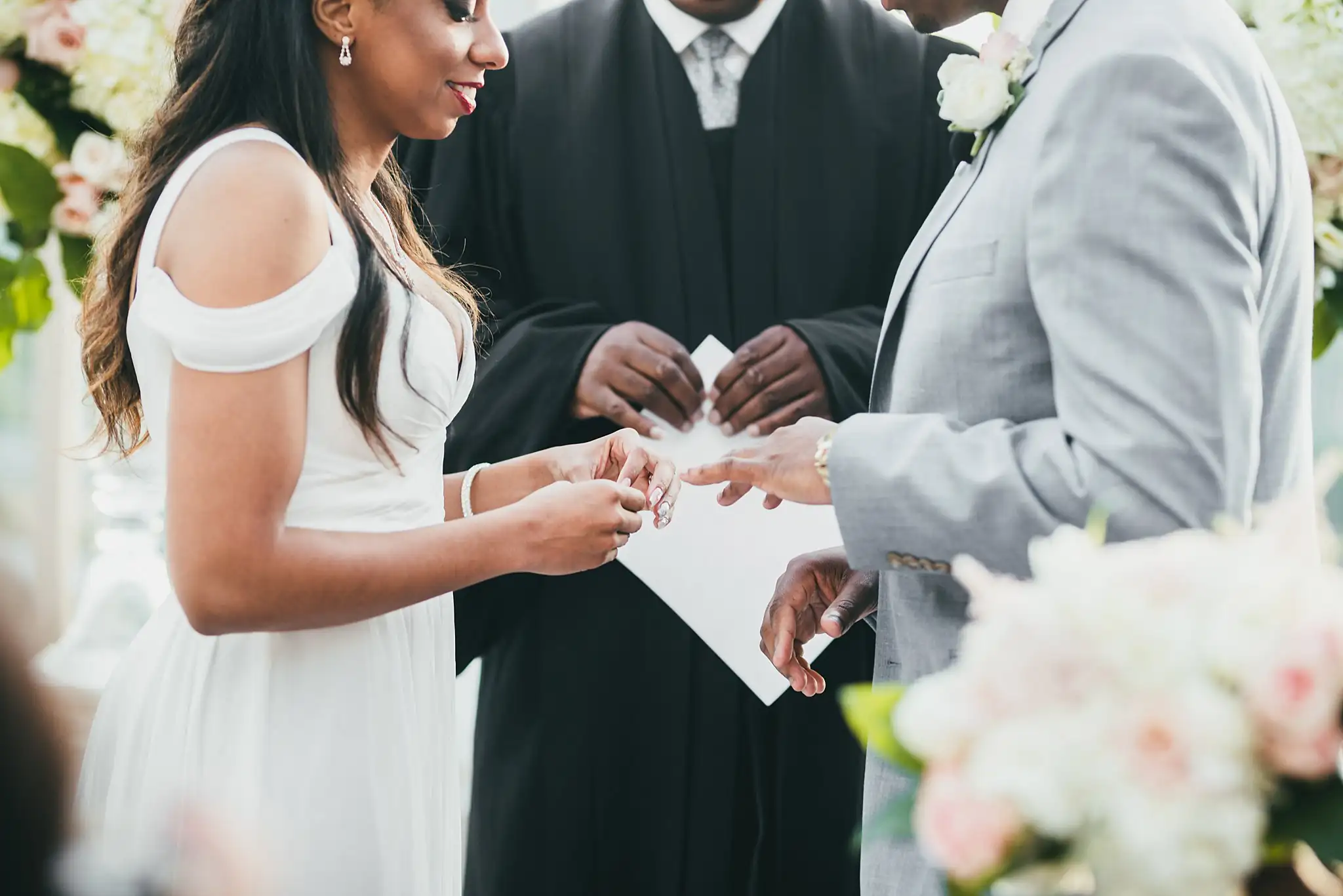 Wedding Ceremony: the ring exchange as the officiant reads, at their elopement at Ventanas in Atlanta, GA