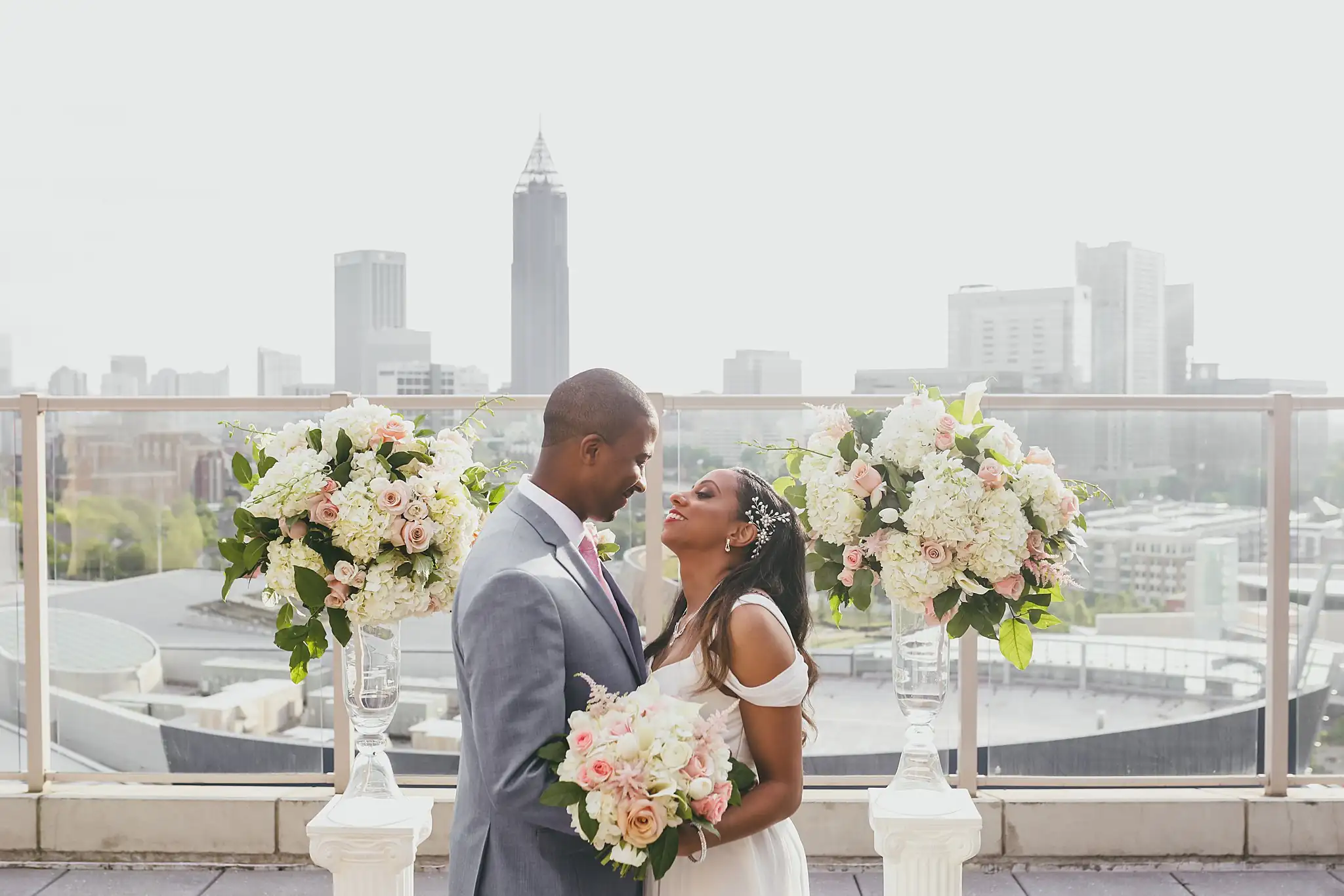Wedding Ceremony: the couple facing each other between the floral columns, at their elopement at Ventanas in Atlanta, GA
