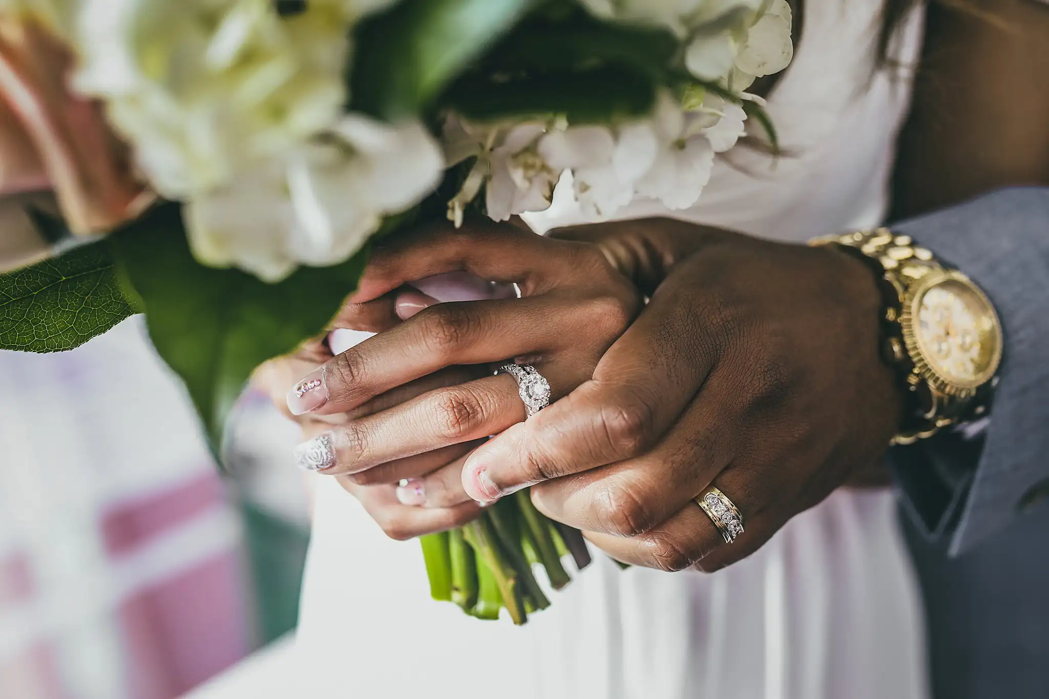 Wedding Details: their hands together with the rings, and the bride's bouquet, at an elopement at Ventanas in Atlanta, GA