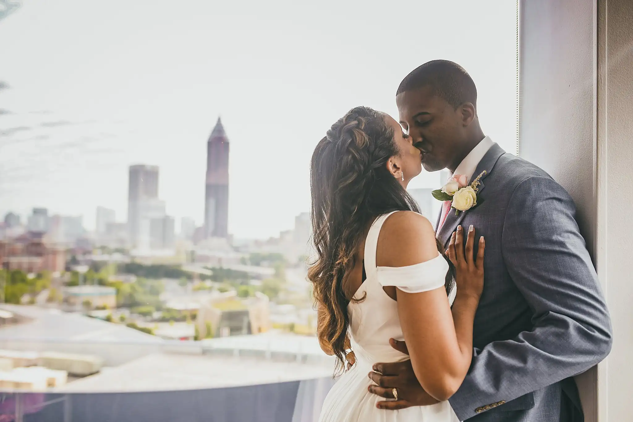 Wedding Formals: the couple kissing at the window, at their elopement at Ventanas in Atlanta, GA