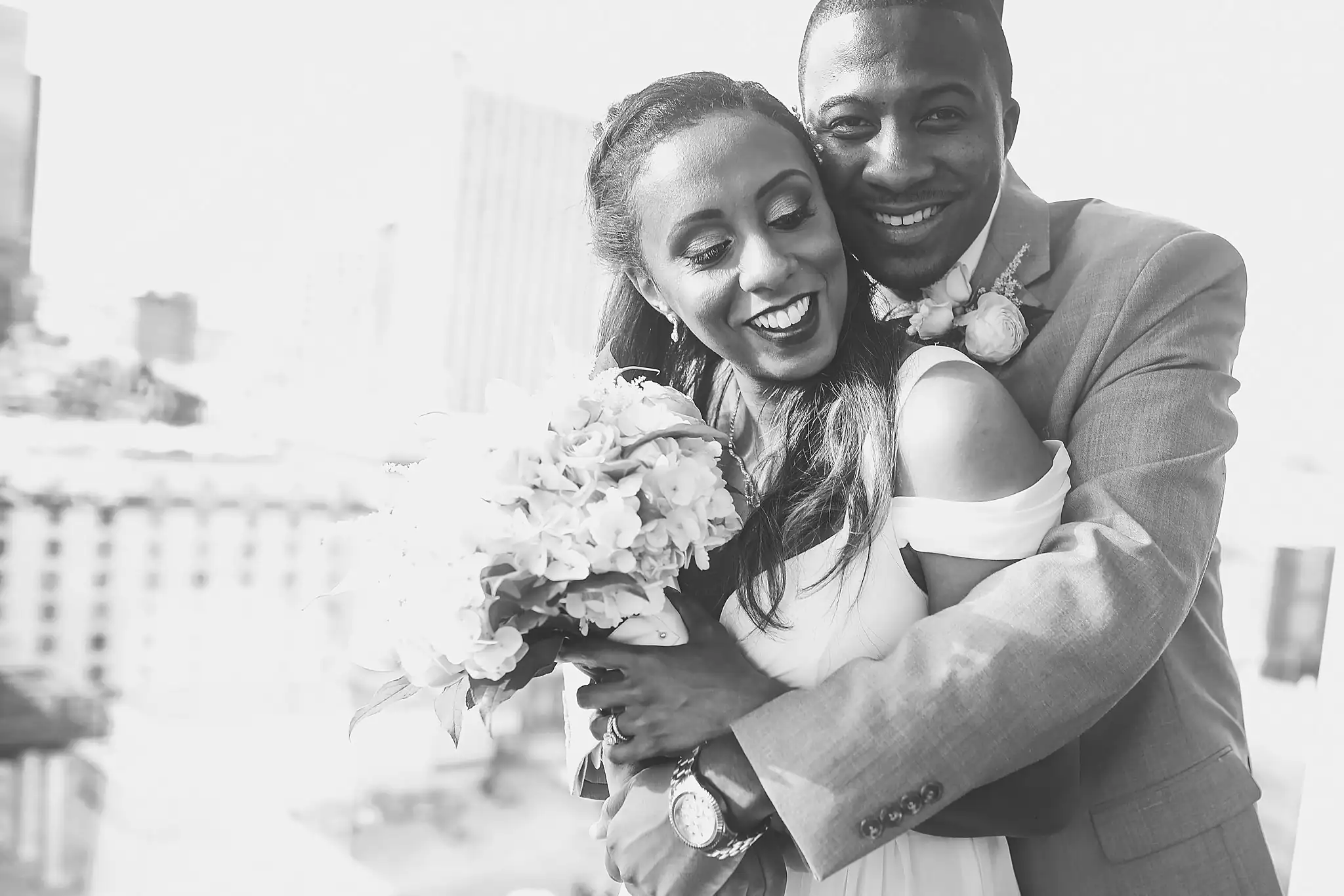 Wedding Formals: the couple laughing with the bouquet, in black and white, at their elopement at Ventanas in Atlanta, GA