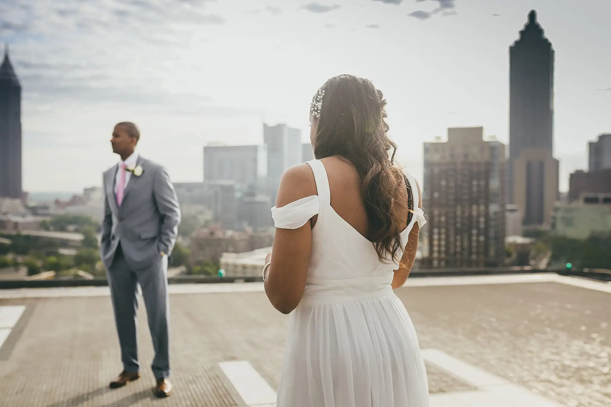 Wedding Formals: the couple standing apart on the helipad, at their elopement at Ventanas in Atlanta, GA