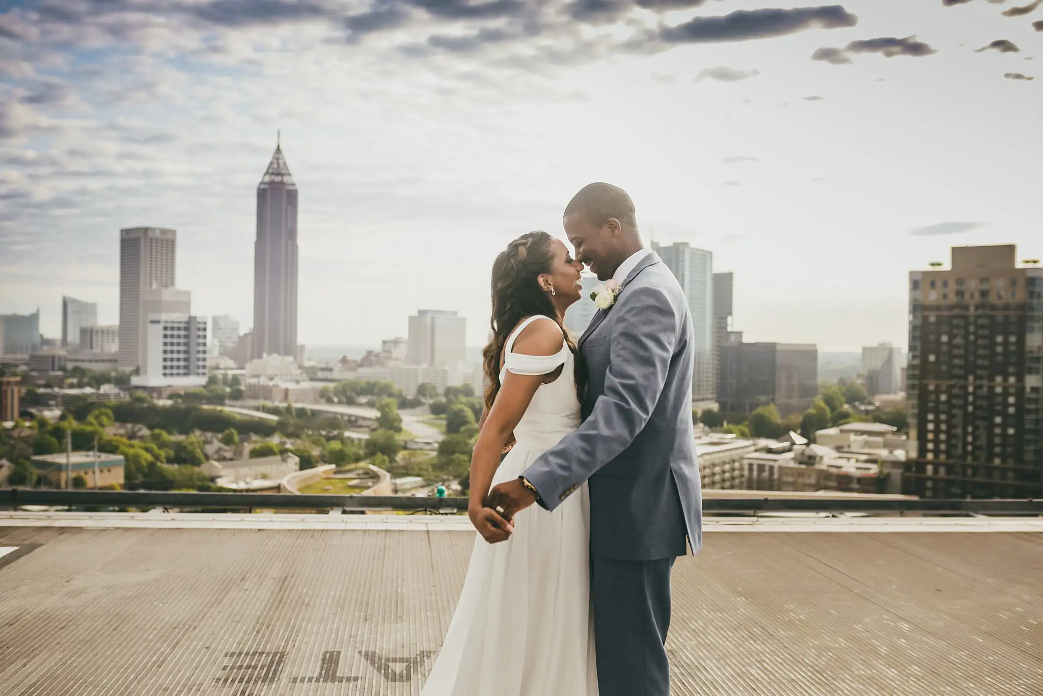 Wedding Formals: the couple embracing on the rooftop helipad, at their elopement at Ventanas in Atlanta, GA