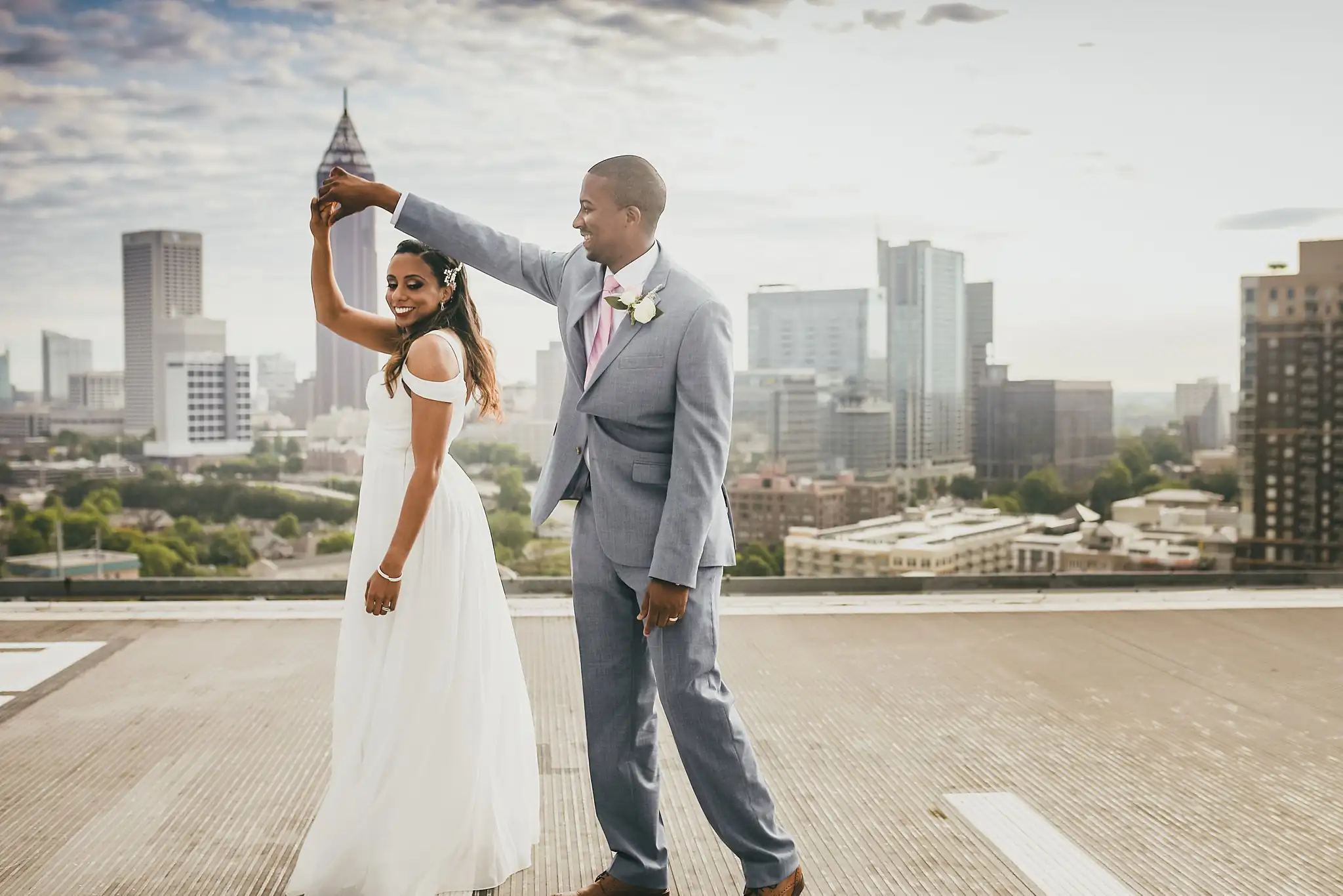 Wedding Formals: the groom turning the bride under his arm on the helipad, at their elopement at Ventanas in Atlanta, GA