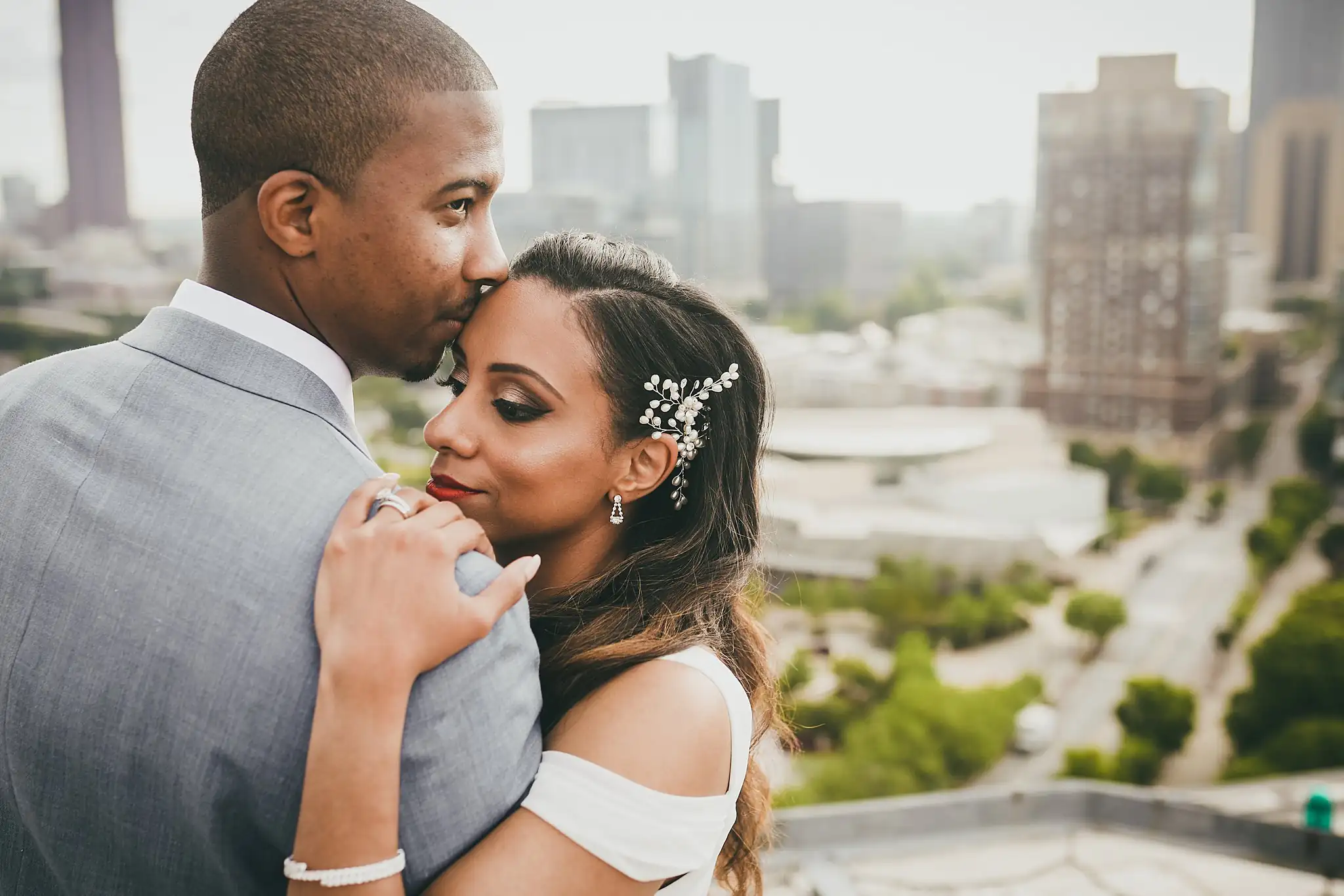 Wedding Formals: the groom kissing the bride's hand at her shoulder, at their elopement at Ventanas in Atlanta, GA