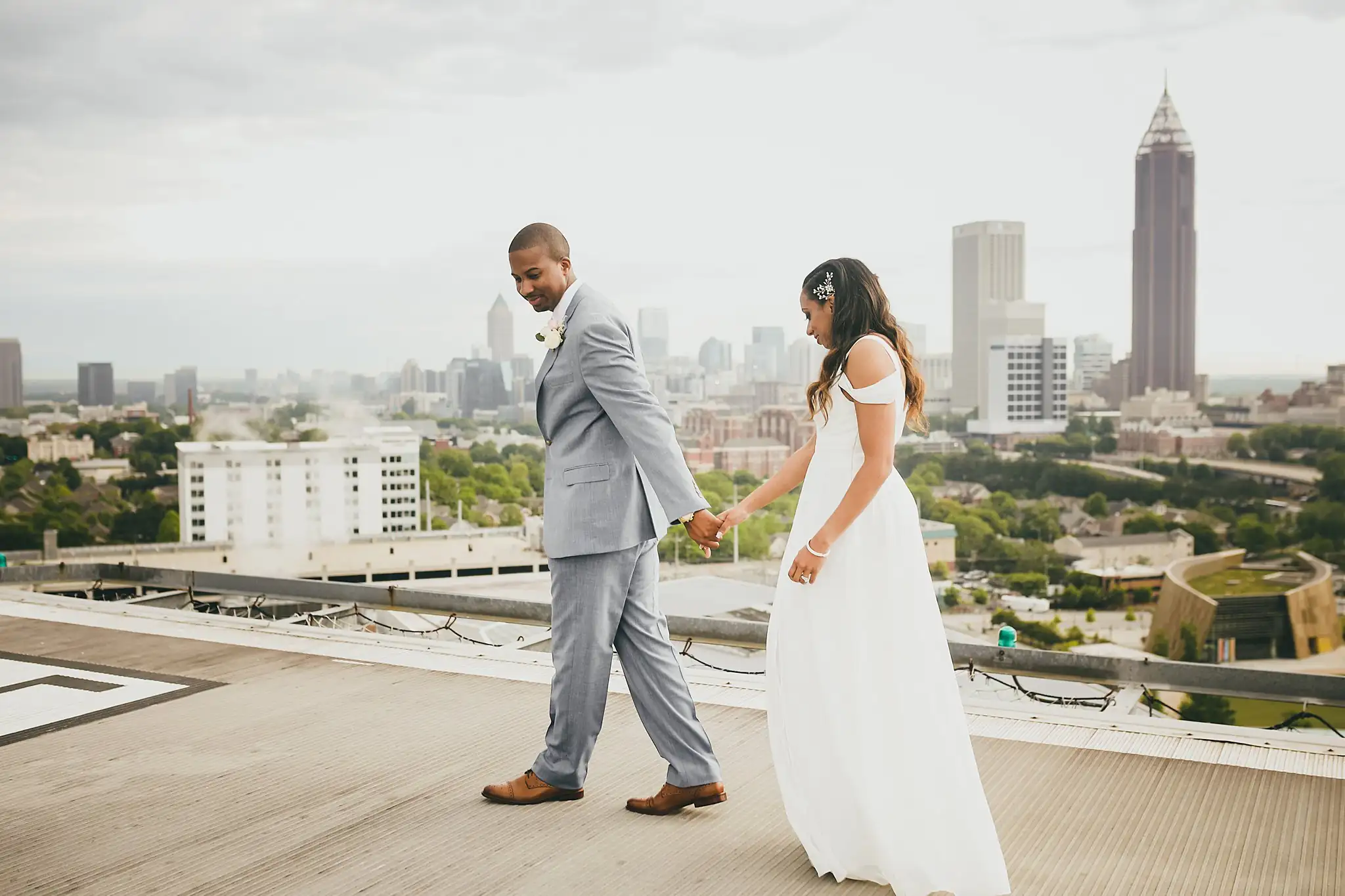 Wedding Formals: the couple walking on, the bride trailing her gown behind her, at their elopement at Ventanas in Atlanta, GA
