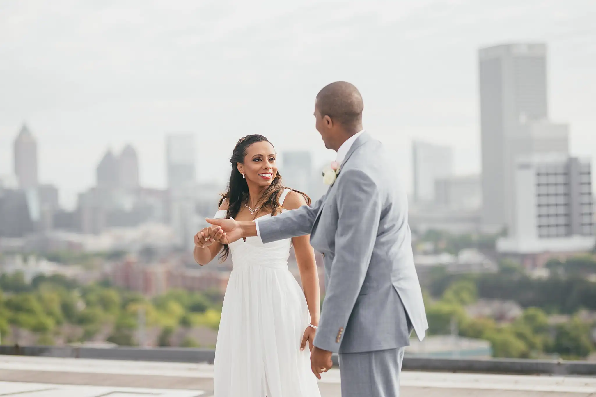 Wedding Formals: the couple dancing together on the rooftop above the skyline, at their elopement at Ventanas in Atlanta, GA