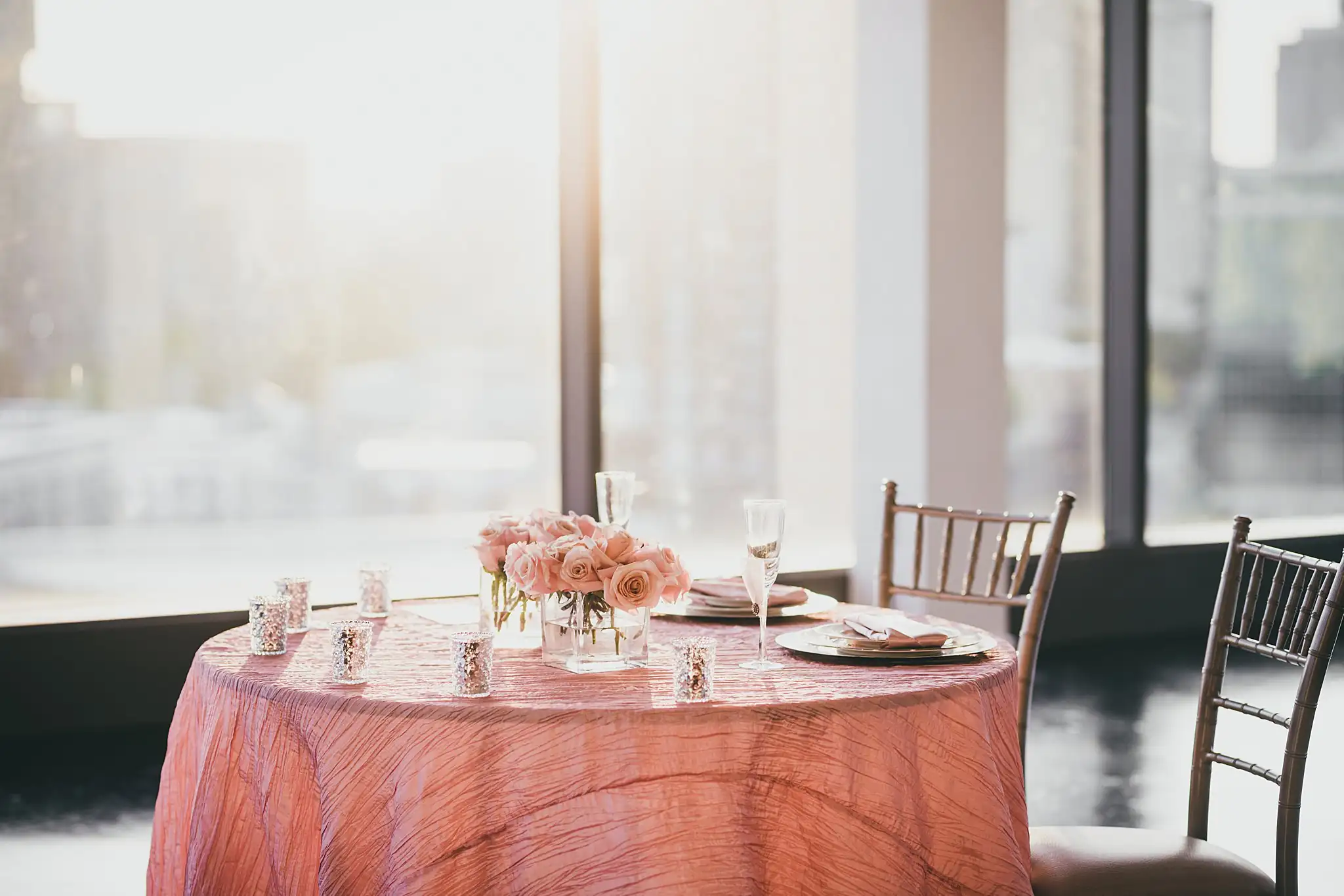 Reception Details: the sweetheart table for two in blush linen beside the windows, at their elopement at Ventanas in Atlanta, GA