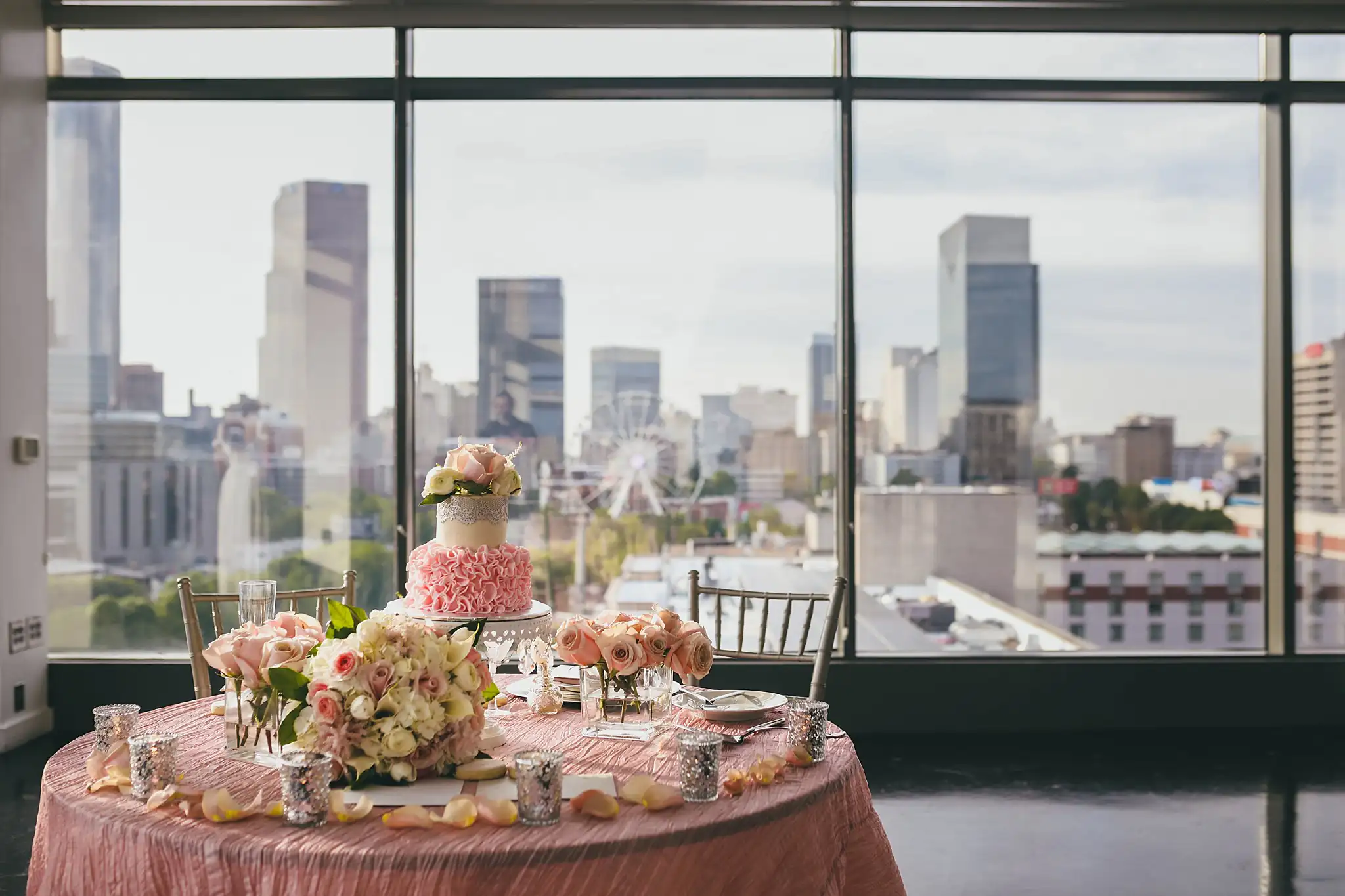 Reception Details: the round table with its blush cake and roses, at their elopement at Ventanas in Atlanta, GA
