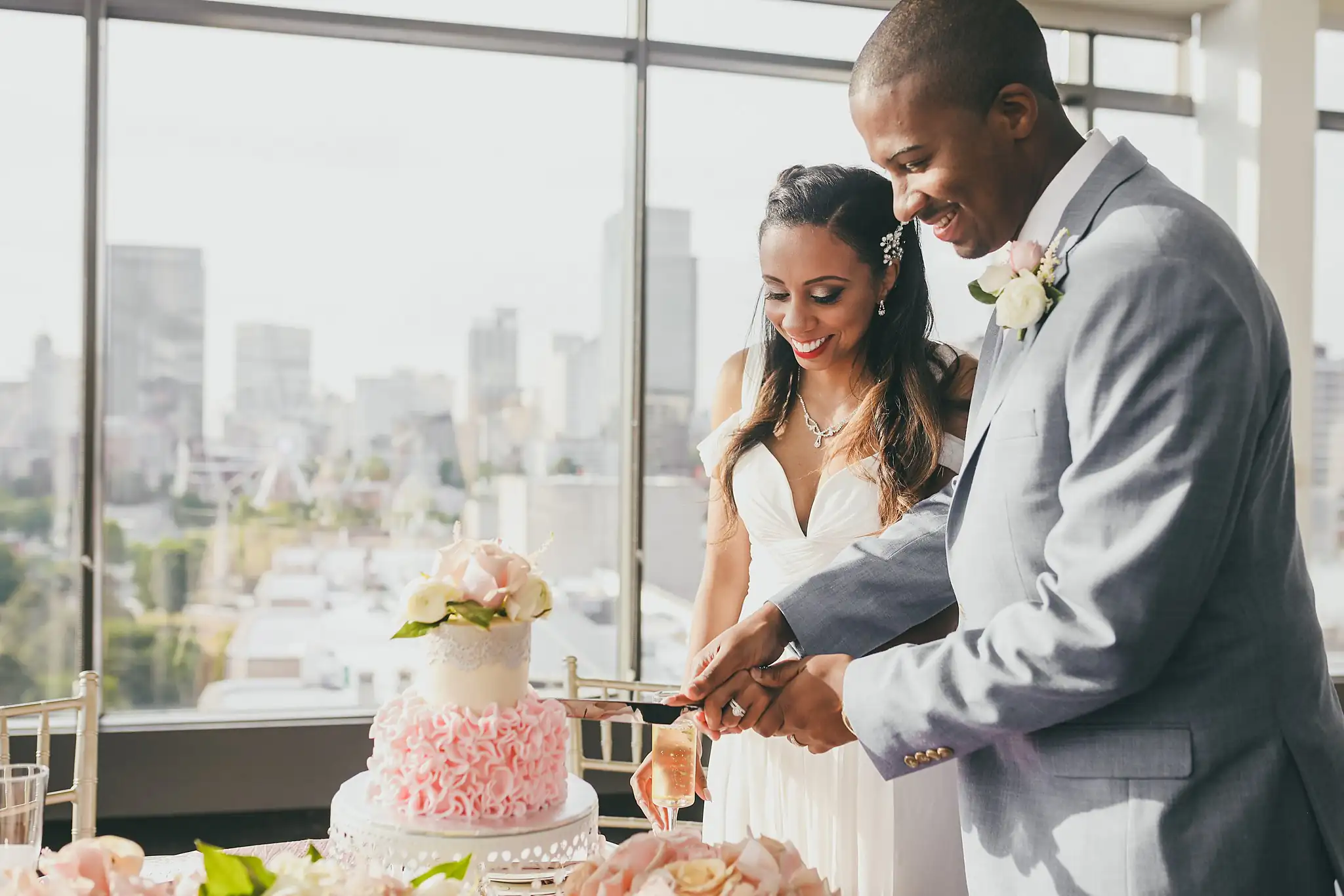 Cake Cutting: the couple cutting their cake by the windows, at their elopement at Ventanas in Atlanta, GA