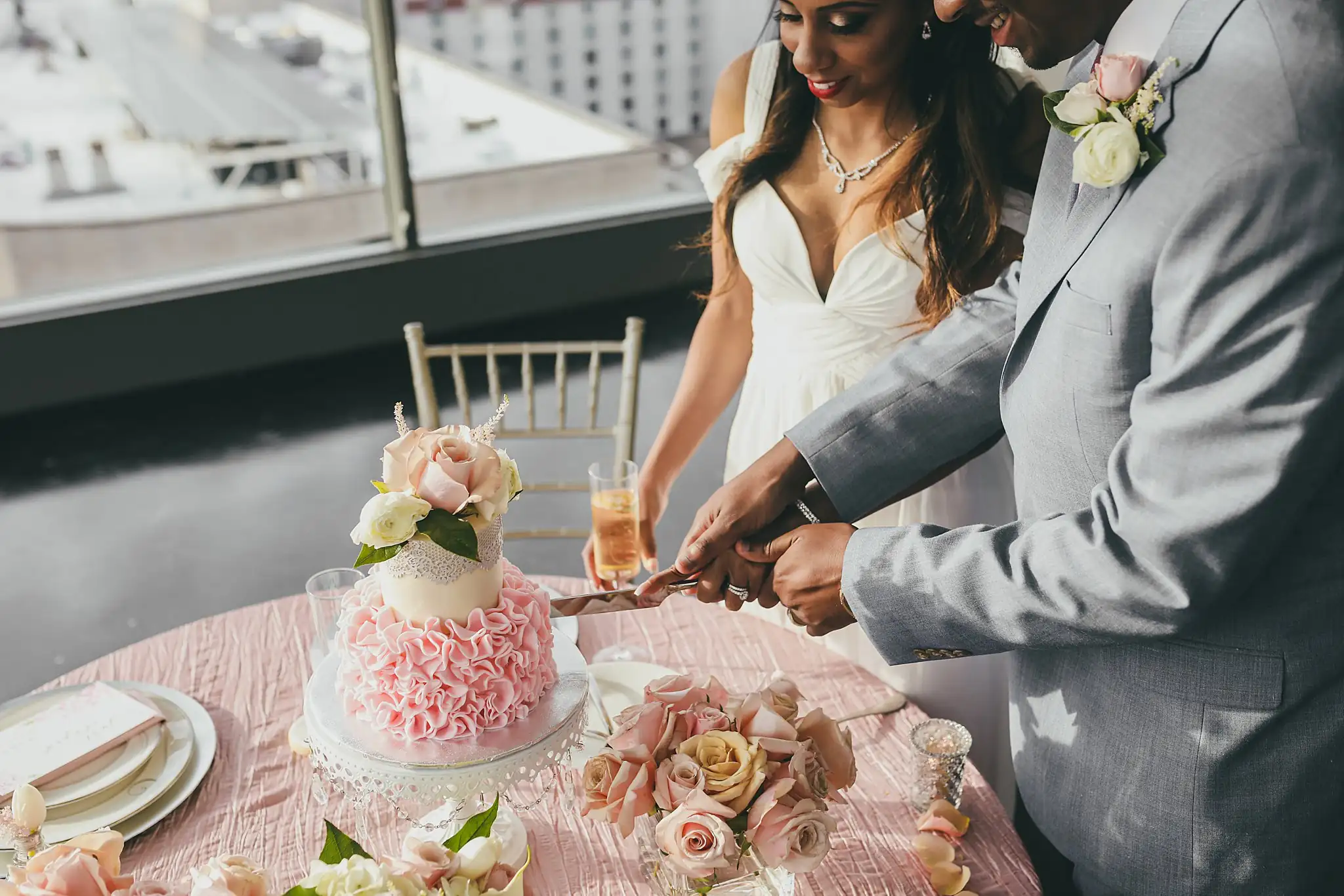 Cake Cutting: the couple cutting the cake, her hand over his, at their elopement at Ventanas in Atlanta, GA