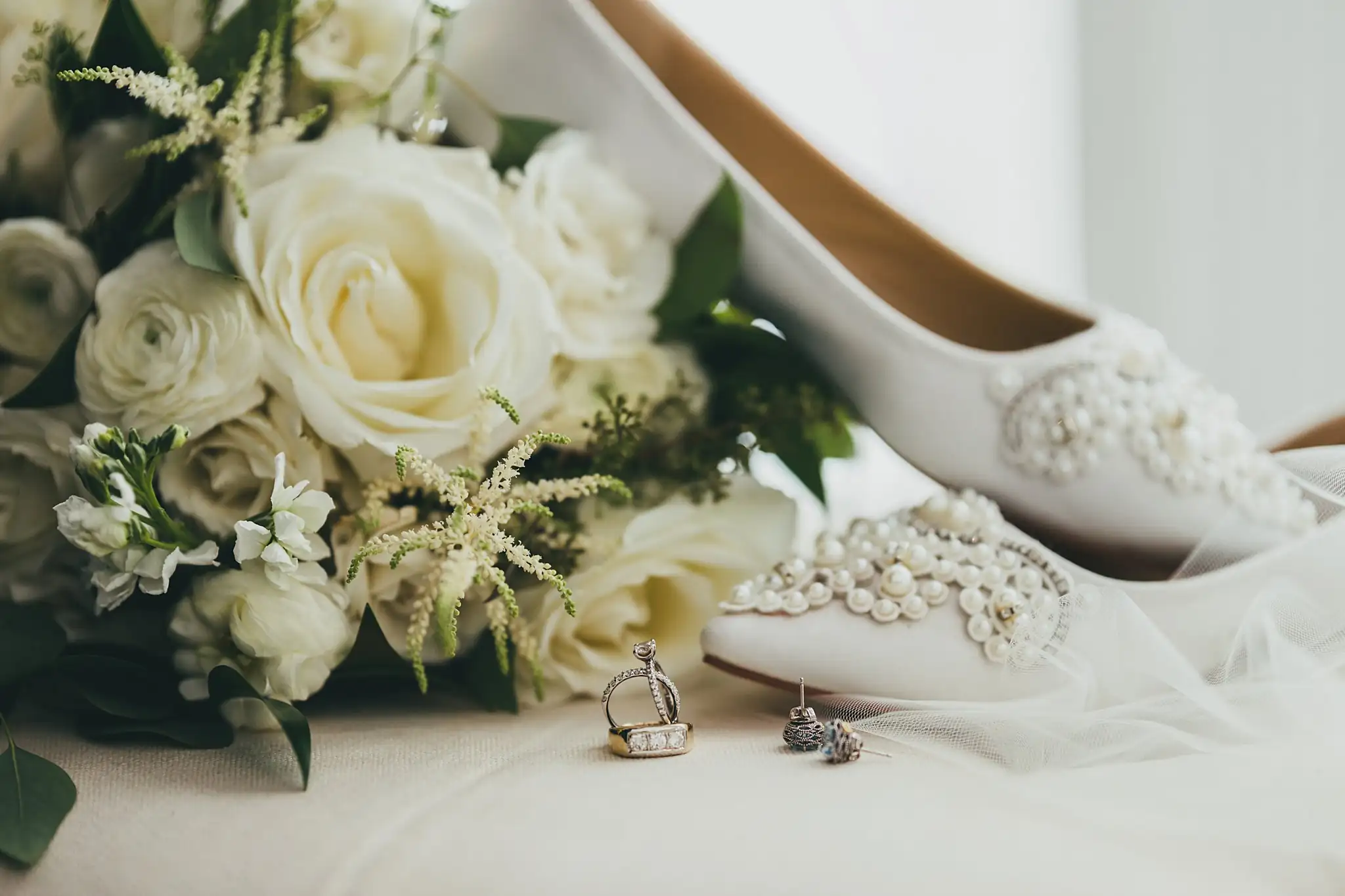 Wedding Details: the white rose bouquet with pearl heels and rings, at a wedding at Little River Farms in Milton, GA