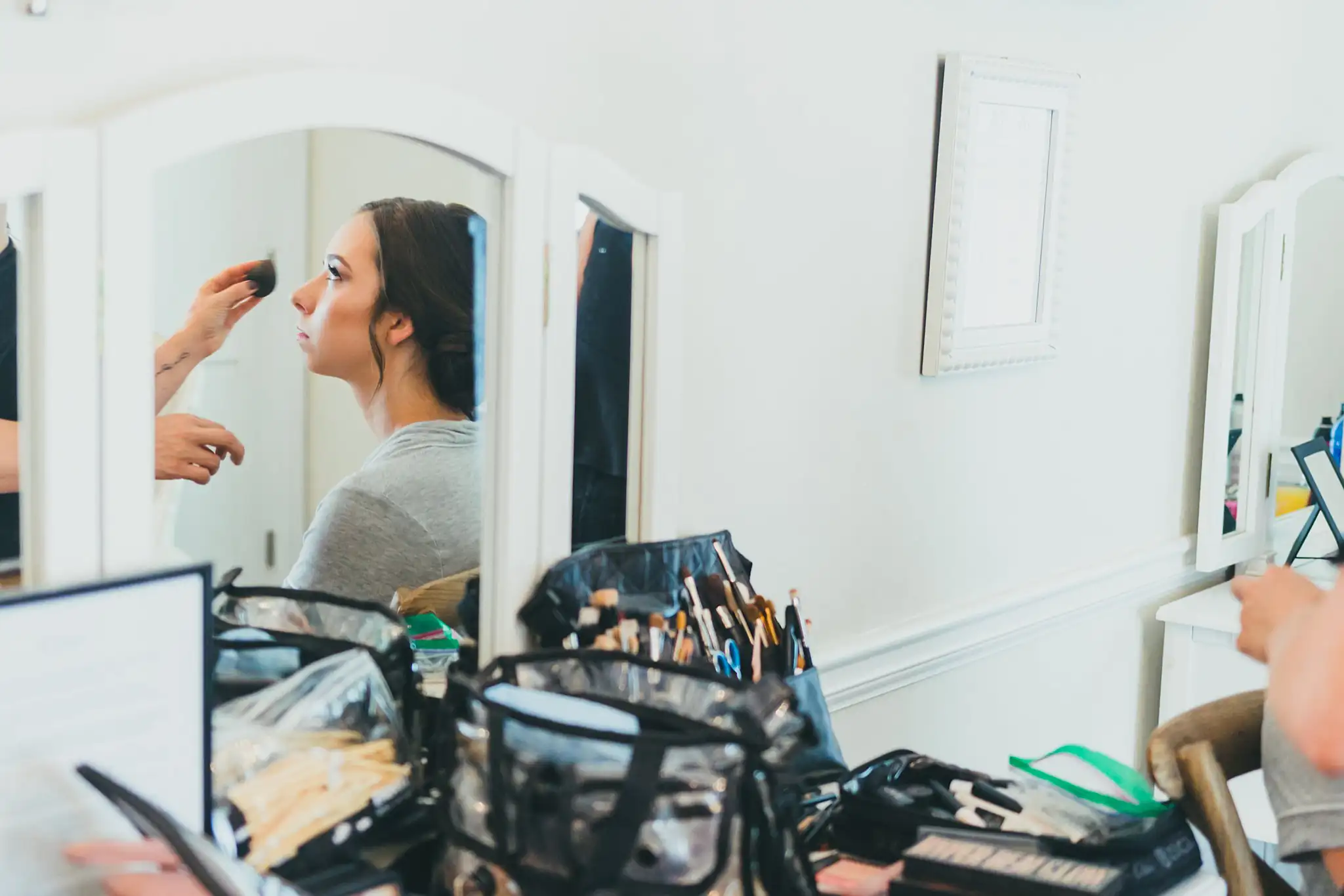 Getting Ready: the bride having her makeup done, before their wedding at Little River Farms in Milton, GA