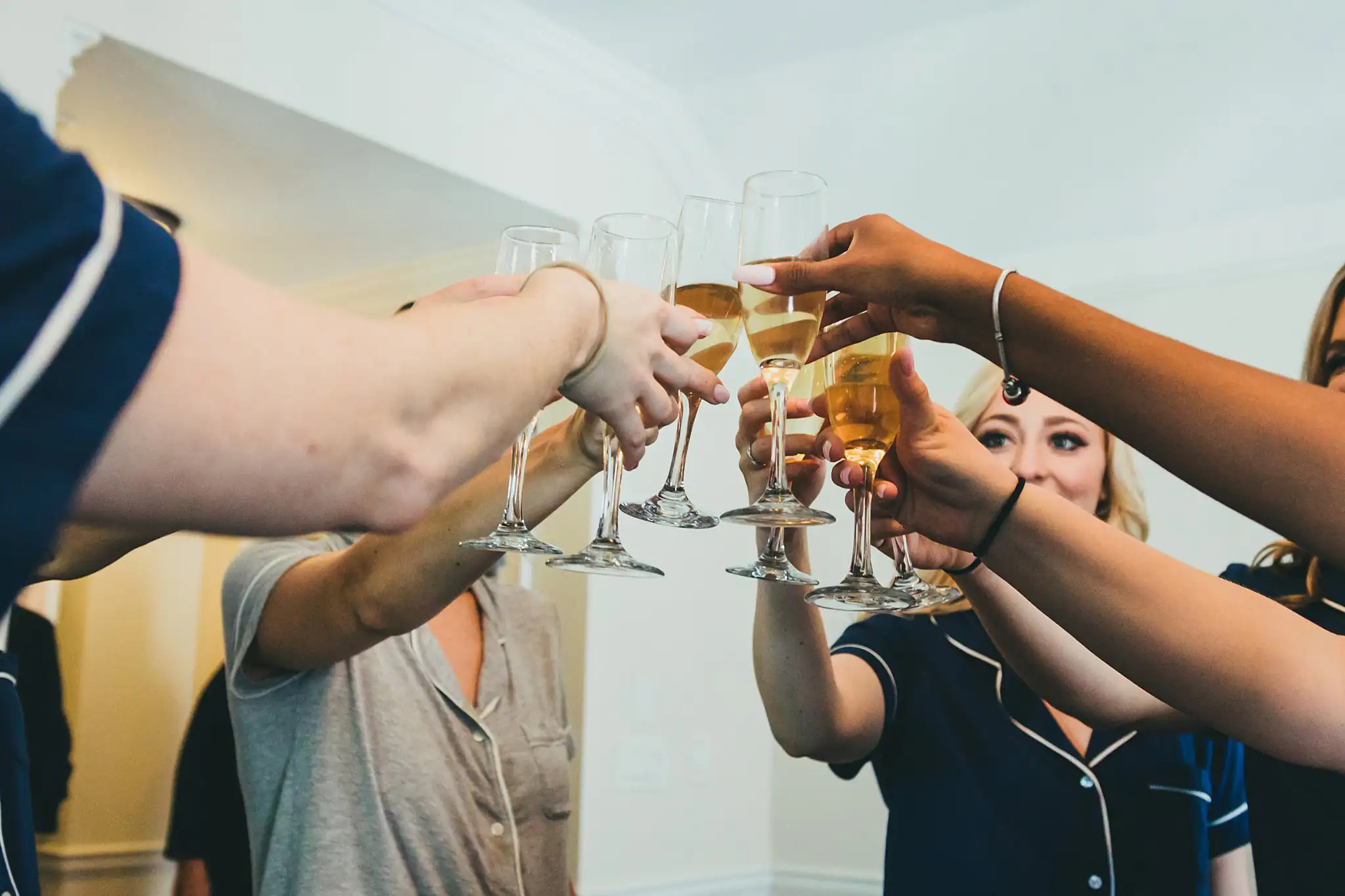 Getting Ready: a champagne toast among the bridesmaids, before their wedding at Little River Farms in Milton, GA