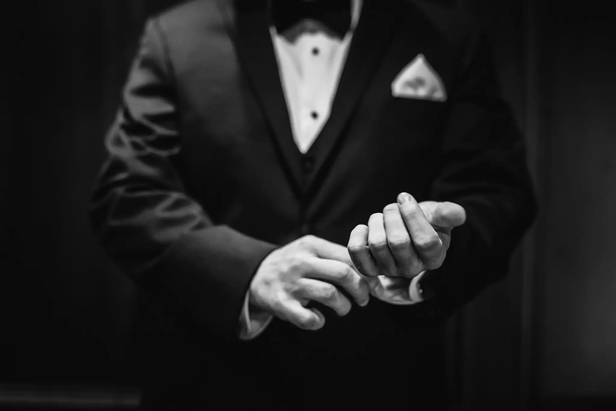 Wedding Details: the groom's hands and pocket square, in black and white, at a wedding at Little River Farms in Milton, GA