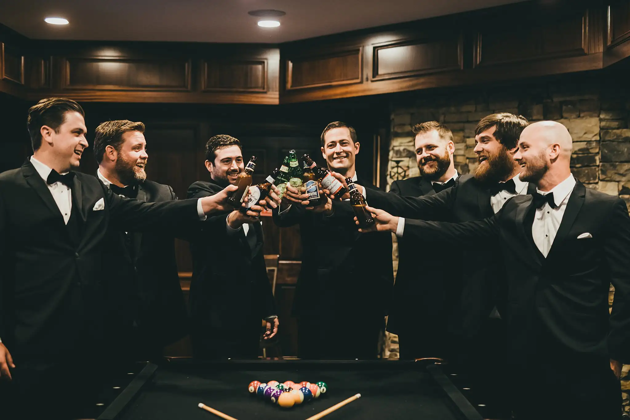 Getting Ready: the groomsmen toasting around the pool table, before their wedding at Little River Farms in Milton, GA