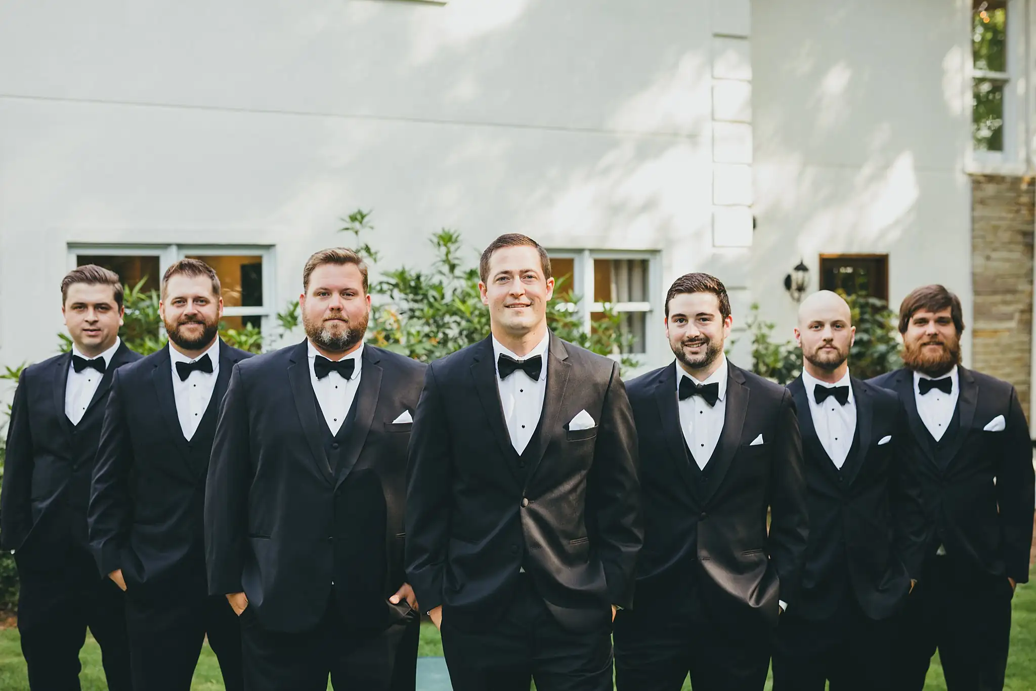 Wedding Party: the groomsmen in black tuxedos on the lawn, at their wedding at Little River Farms in Milton, GA