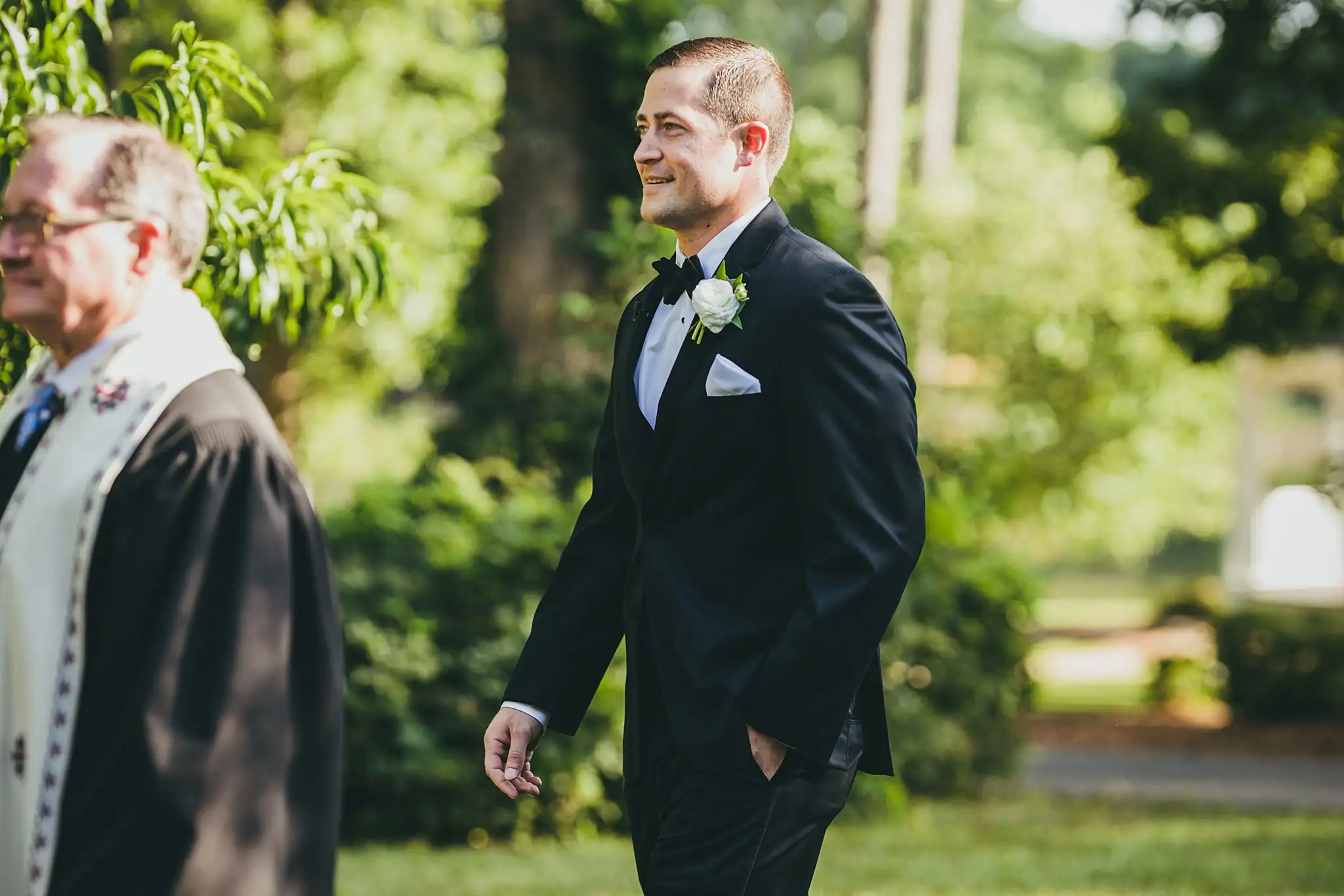 Wedding Ceremony: the groom walking in with the officiant, at their wedding at Little River Farms in Milton, GA