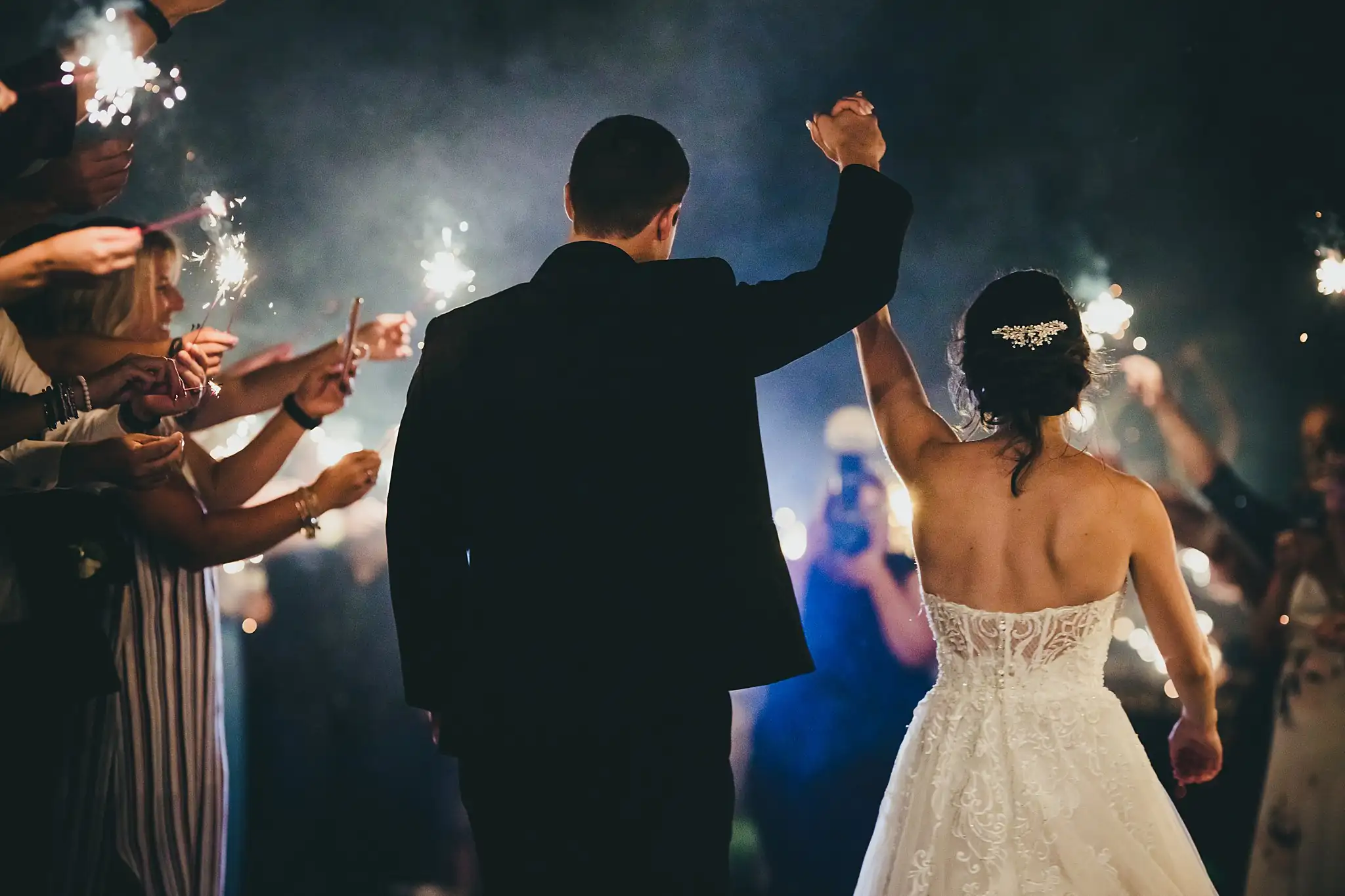 Sparkler Exit: the couple walking out through the sparklers, at their wedding at Little River Farms in Milton, GA