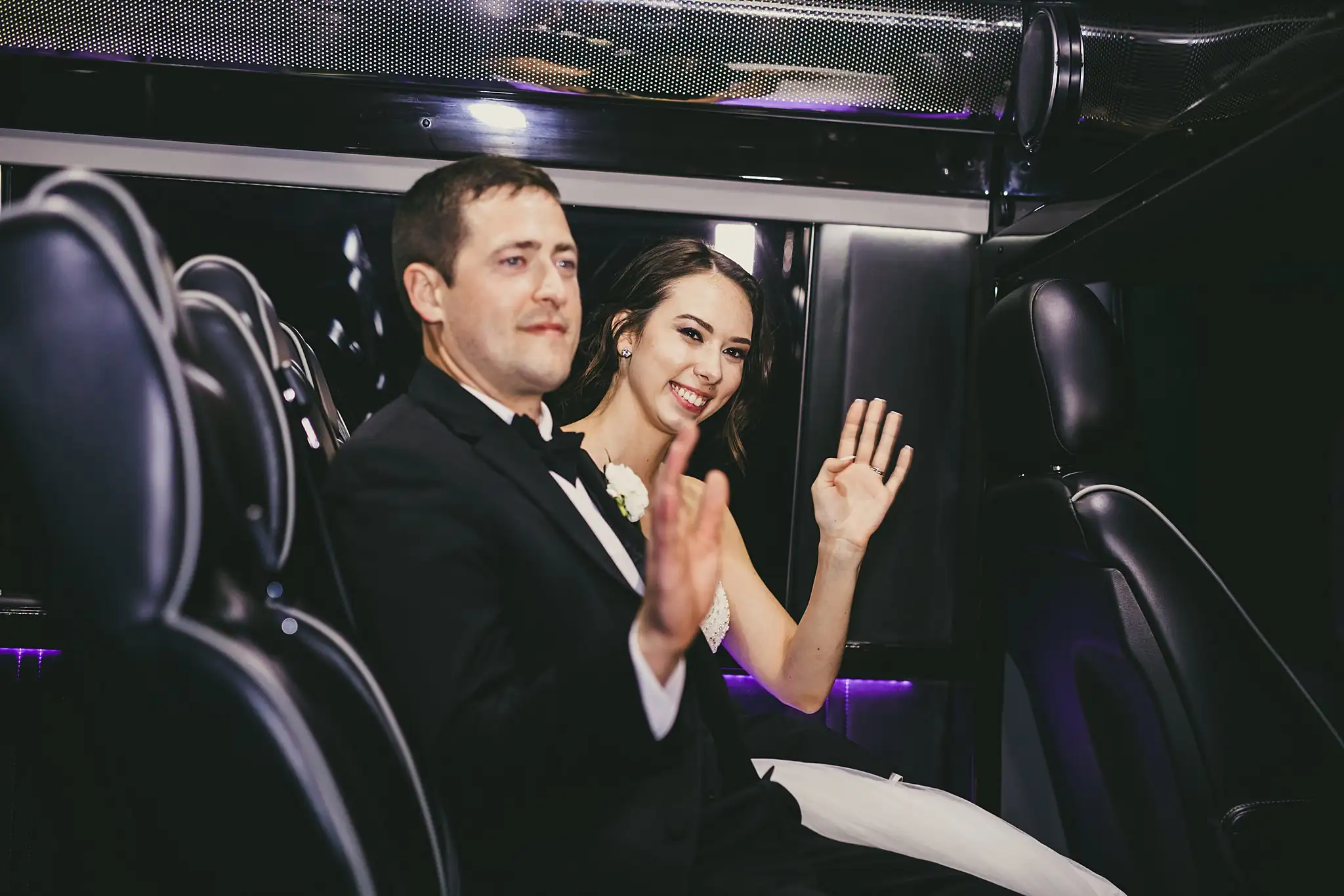 Send-Off: the couple waving from the back of the shuttle, at their wedding at Little River Farms in Milton, GA