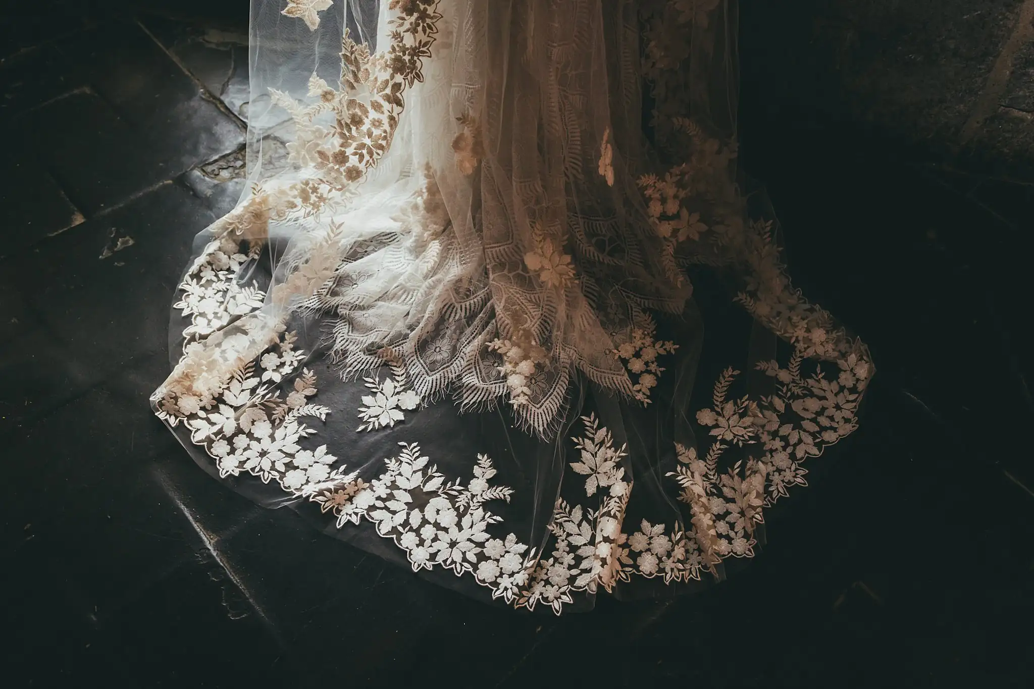 Wedding Details: the lace-edged veil spread on a dark floor, at a wedding at the Piedmont Garden Tent in Atlanta, GA