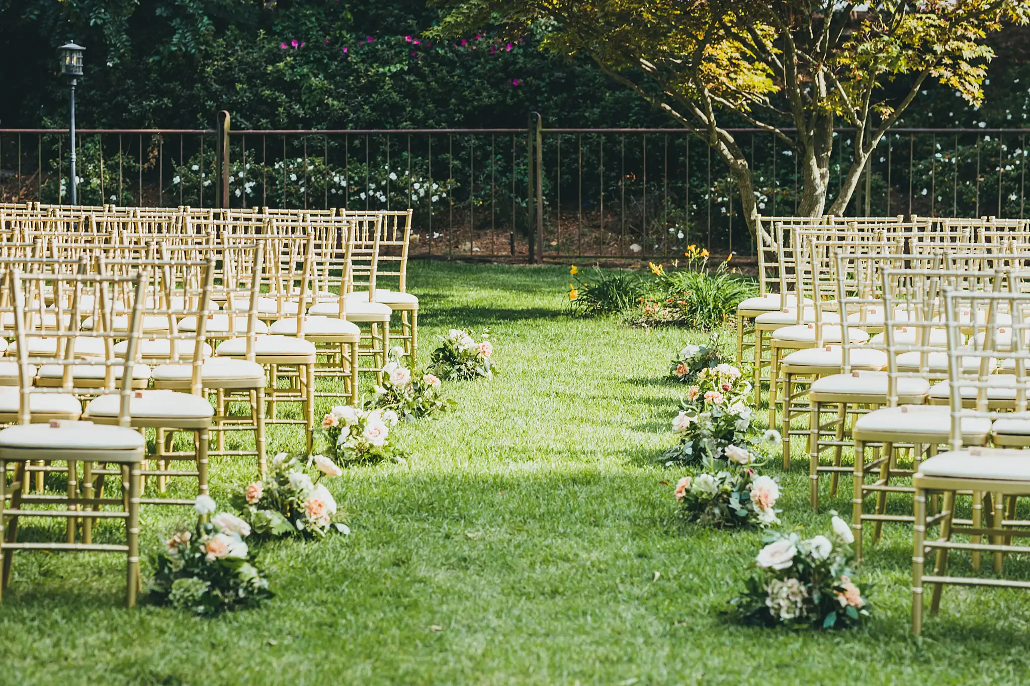 Wedding Ceremony: the chairs from the side, flowers on the grass, at a wedding at the Piedmont Garden Tent in Atlanta, GA