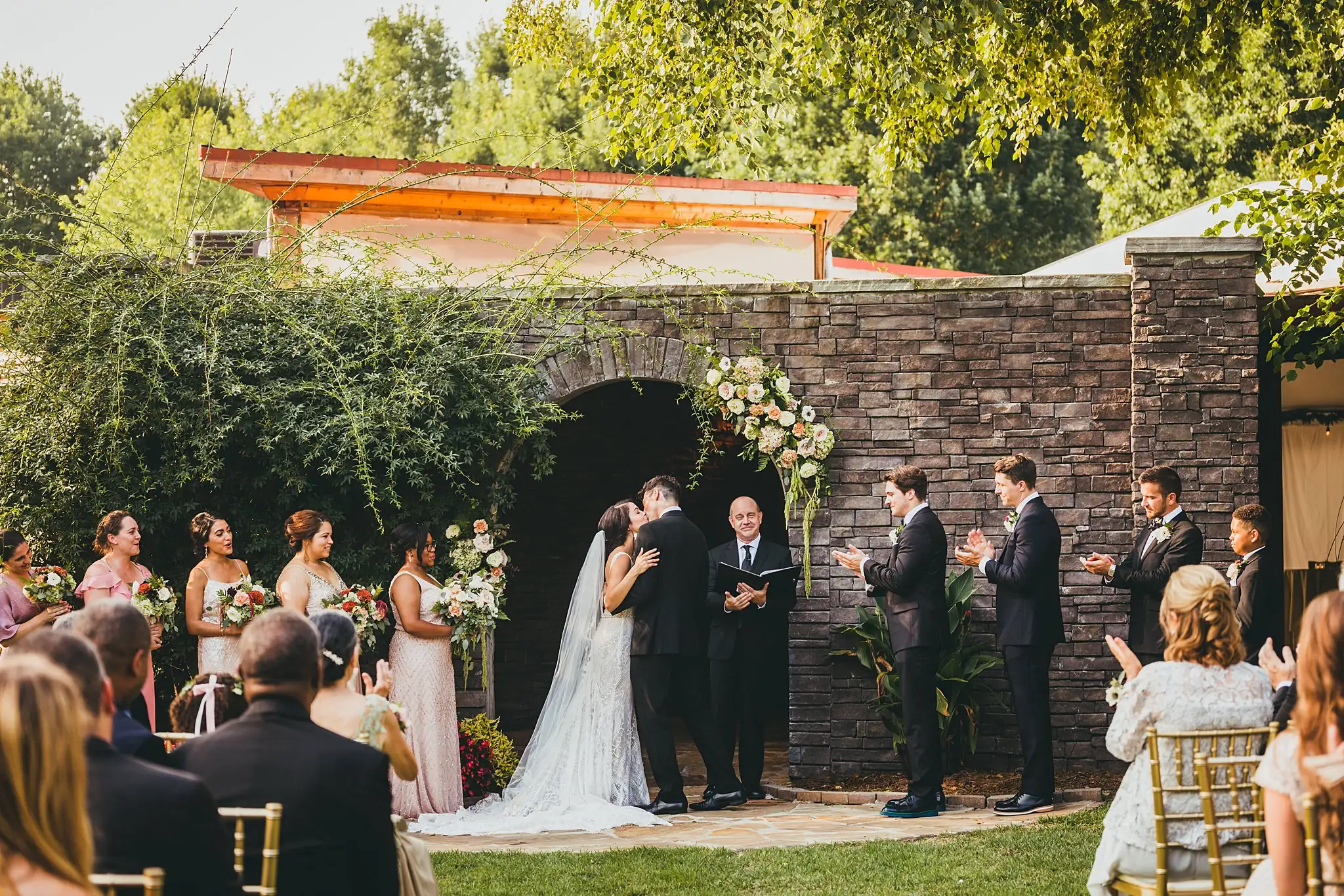 Wedding Ceremony: the couple at the altar, guests all around, at their wedding at the Piedmont Garden Tent in Atlanta, GA