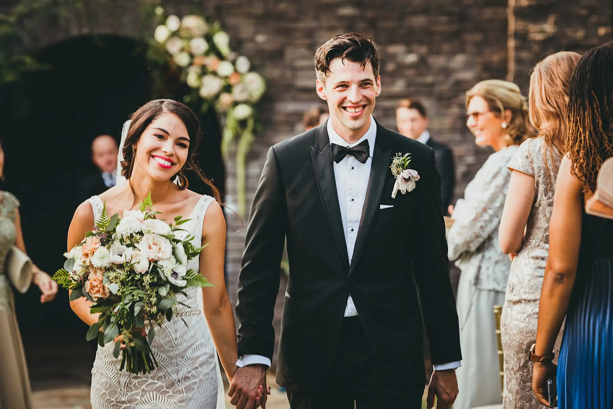 Recessional: the couple walking out hand in hand, at their wedding at the Piedmont Garden Tent in Atlanta, GA