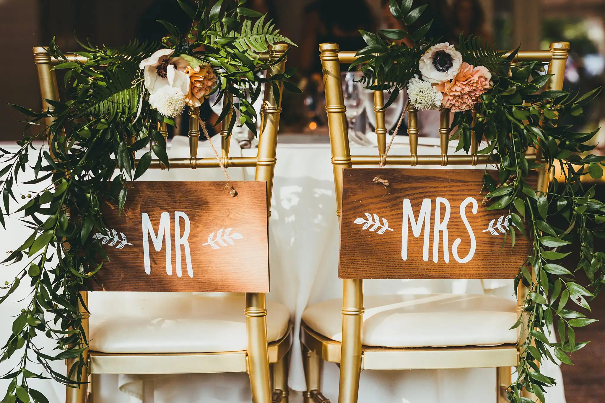 Reception Details: the MR and MRS chairs with greenery garlands, at their wedding at the Piedmont Garden Tent in Atlanta, GA