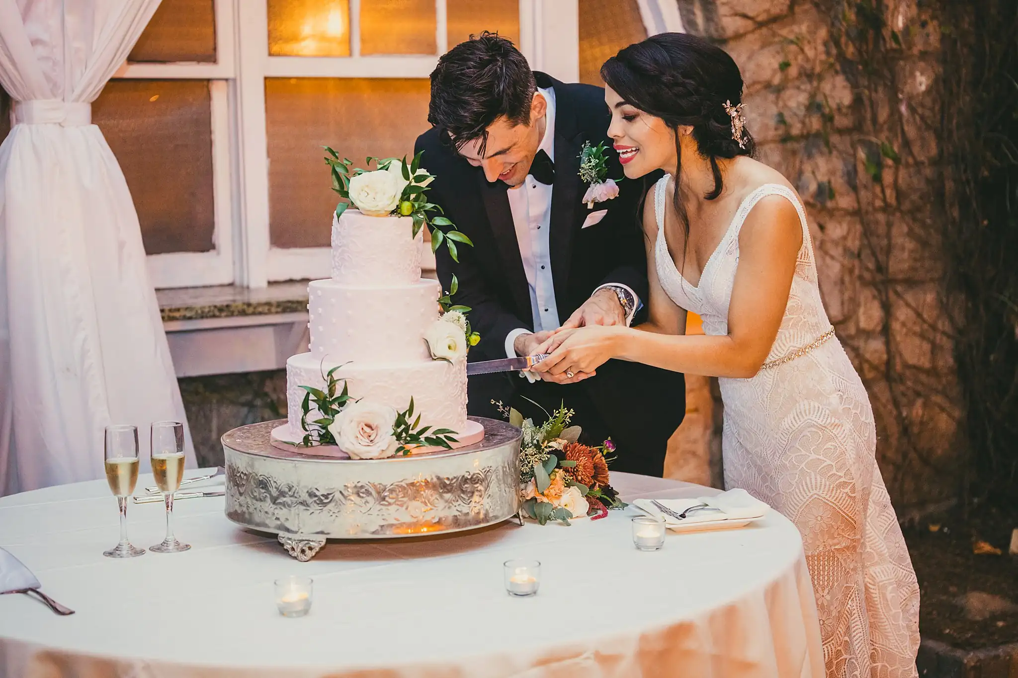 Cake Cutting: the couple cutting the blush cake, at their wedding at the Piedmont Garden Tent in Atlanta, GA
