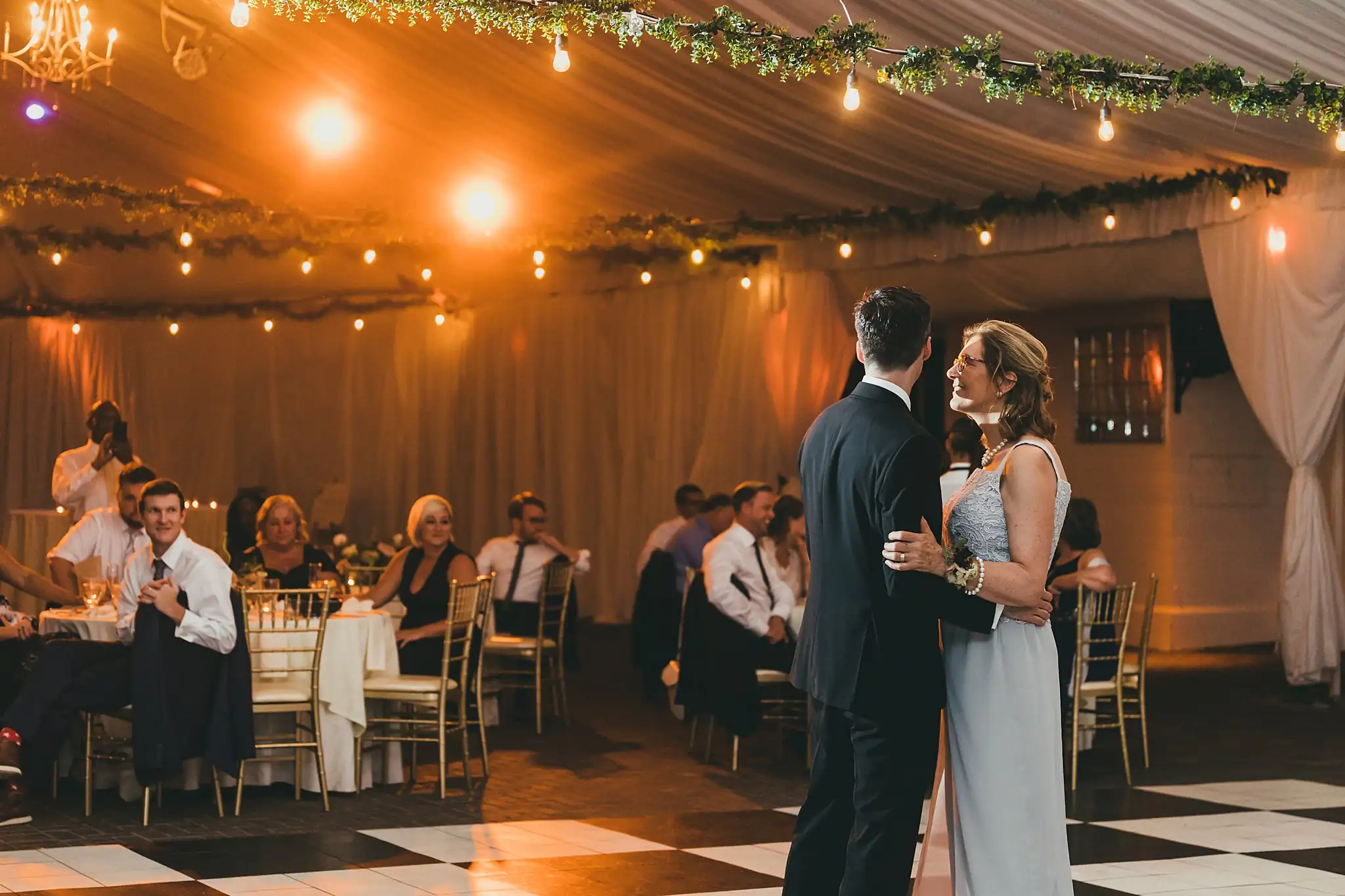 Parent Dance: the groom dancing with his mother under the tent, at their wedding at the Piedmont Garden Tent in Atlanta, GA