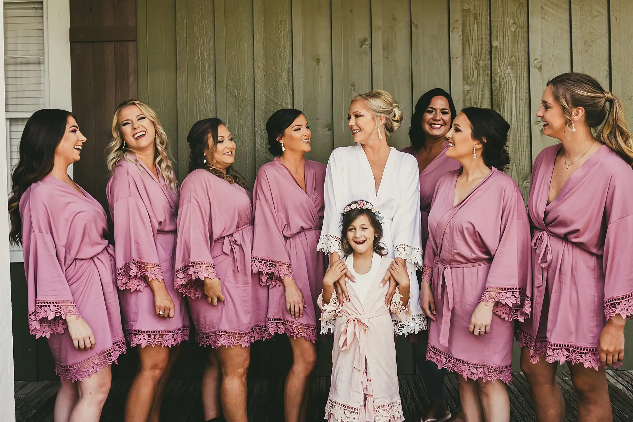 Getting Ready: the bride and her bridesmaids in dusty rose robes, before their wedding at Houston Lake Country Club in Perry, GA