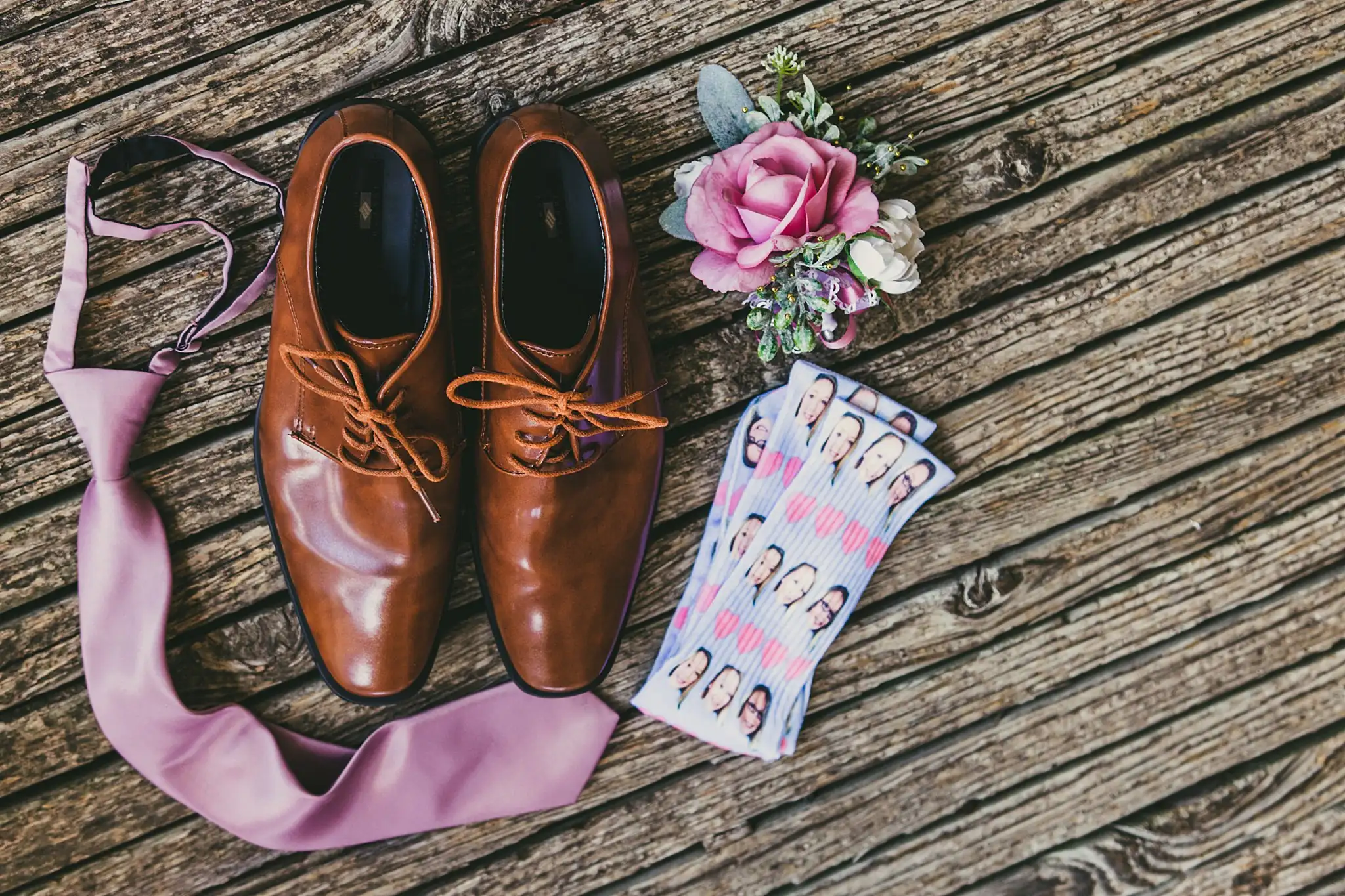 Wedding Details: the groom's oxfords, tie and boutonniere laid out, at a wedding at Houston Lake Country Club in Perry, GA