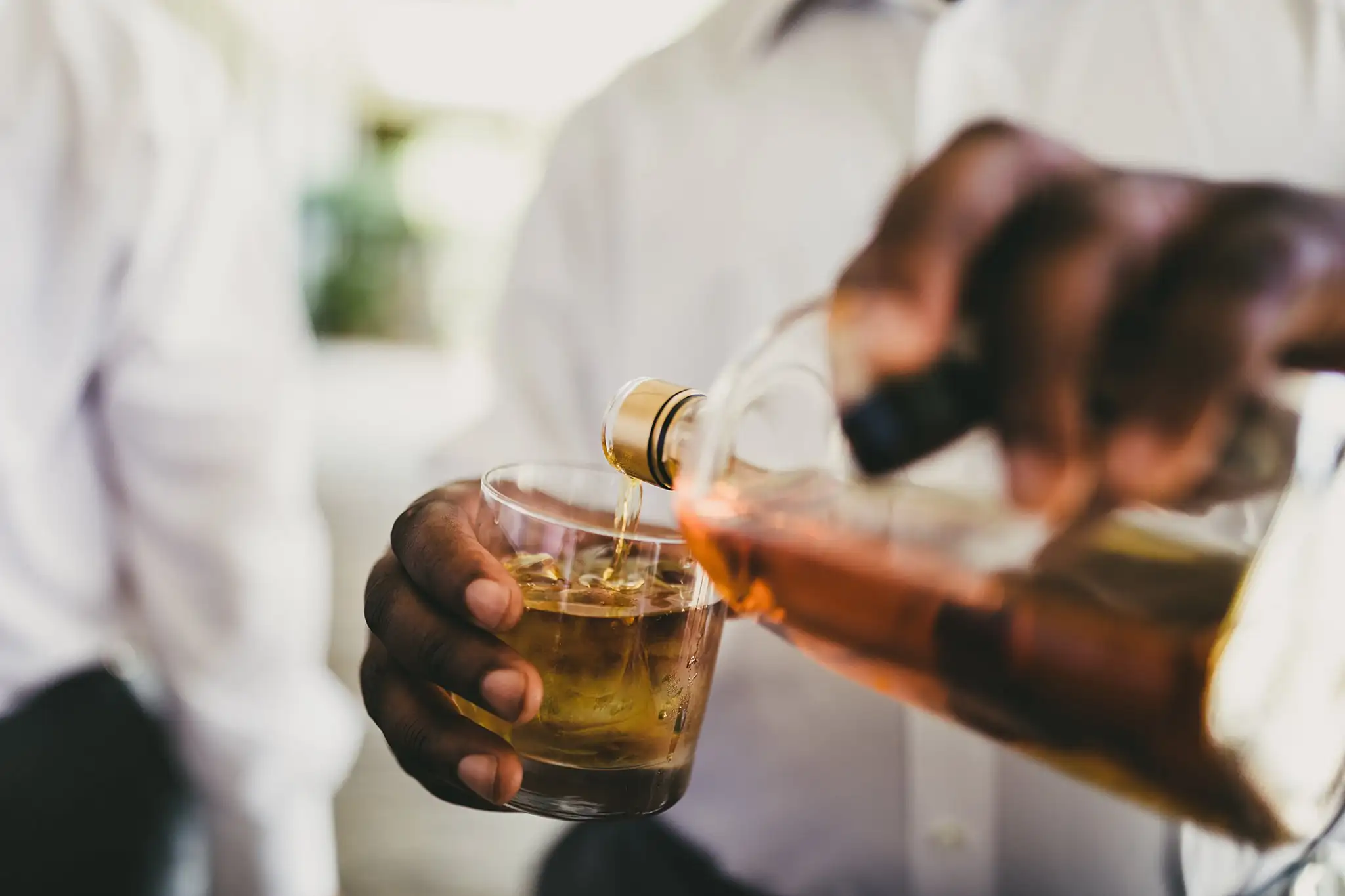 Getting Ready: whiskey being poured for the groomsmen, before their wedding at Houston Lake Country Club in Perry, GA