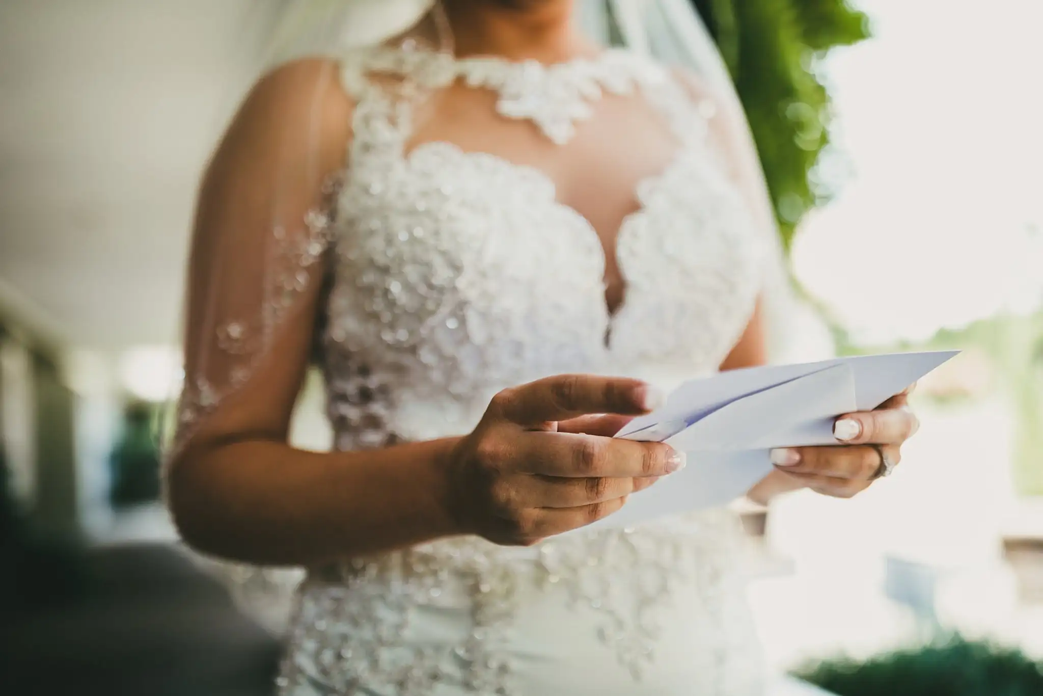 Getting Ready: the bride's lace bodice as she reads, before their wedding at Houston Lake Country Club in Perry, GA