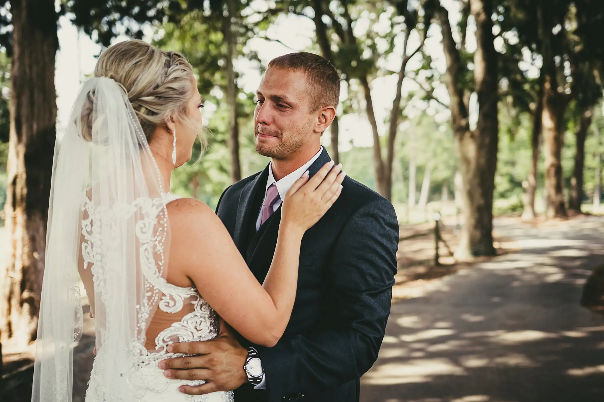 First Look: the groom's reaction, her hand on his cheek, before their wedding at Houston Lake Country Club in Perry, GA