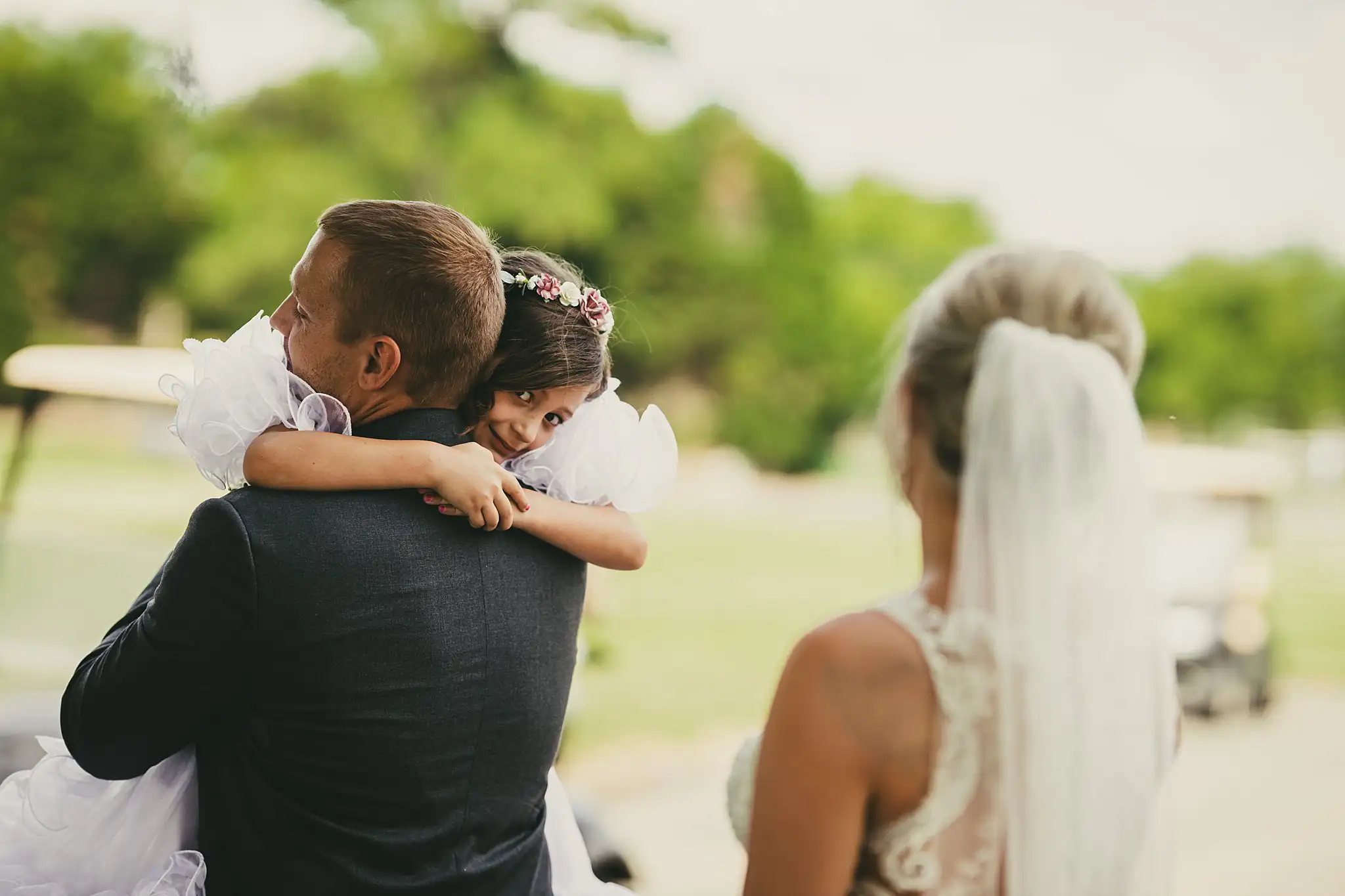 Wedding Formals: the groom lifting the flower girl into a hug, at their wedding at Houston Lake Country Club in Perry, GA